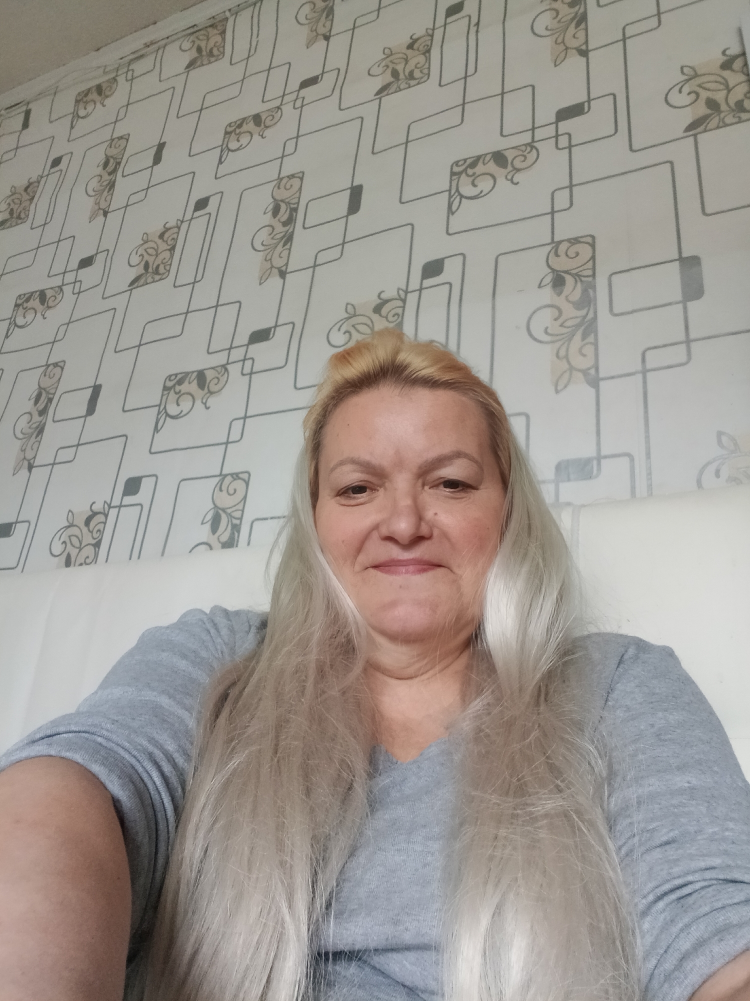 Woman photographed sitting indoors in Красный Маяк, Russia
