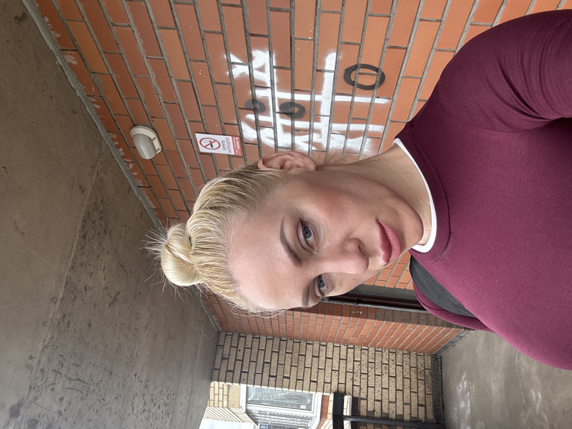 Woman takes selfies in urban neighborhood setting