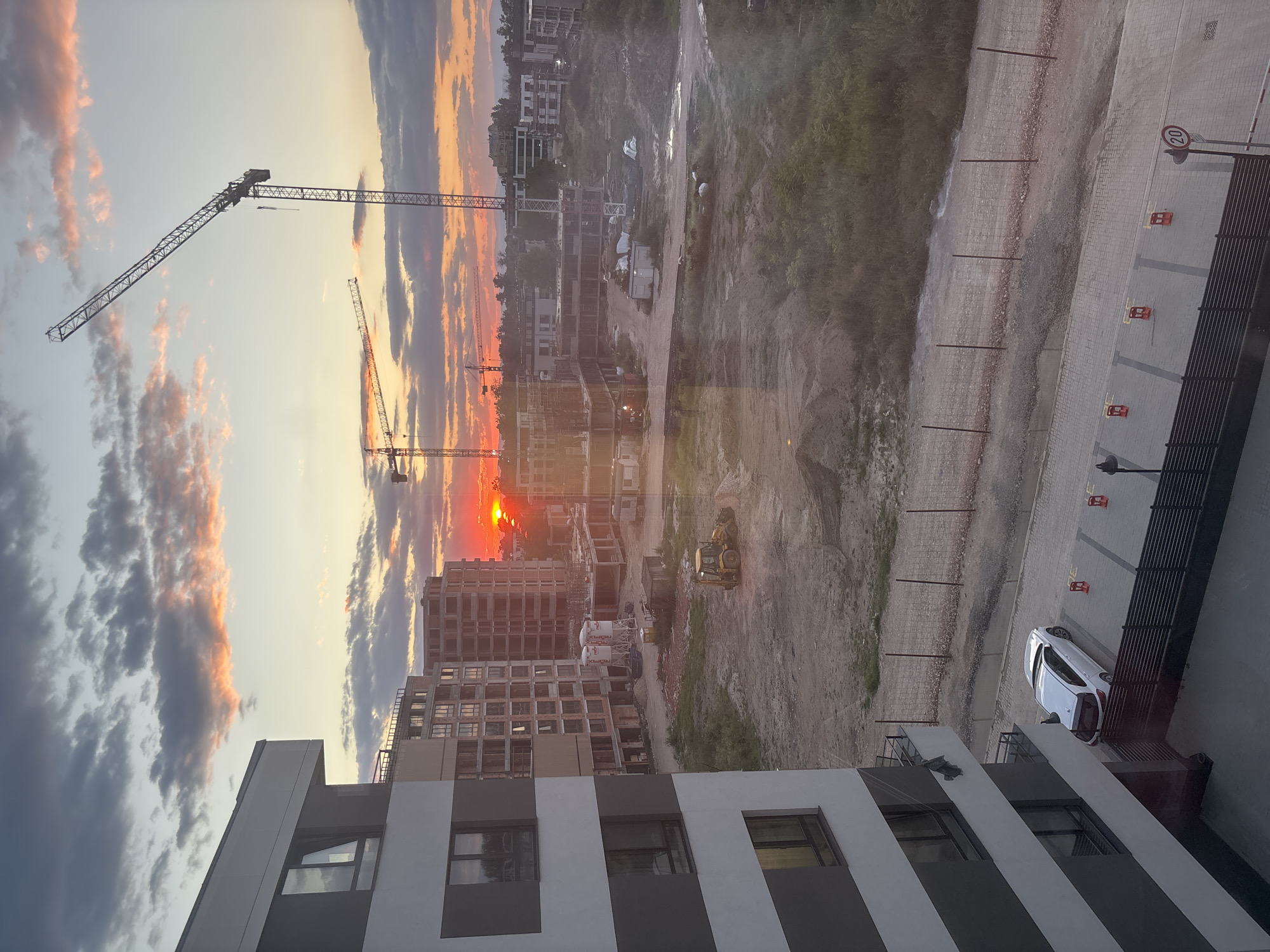Urban construction site at sunset, two angles