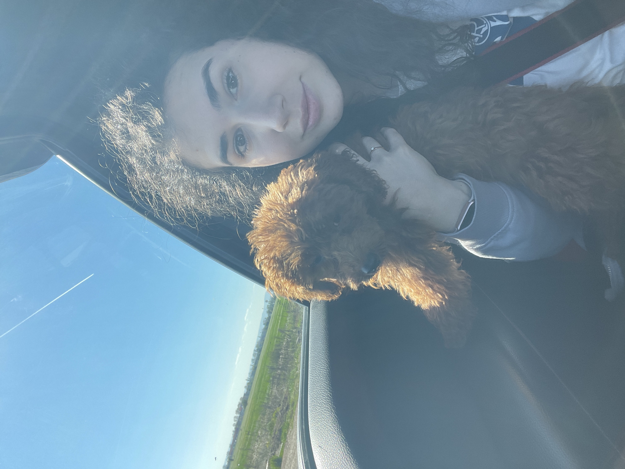 Woman and poodle enjoy car ride through Sofia countryside