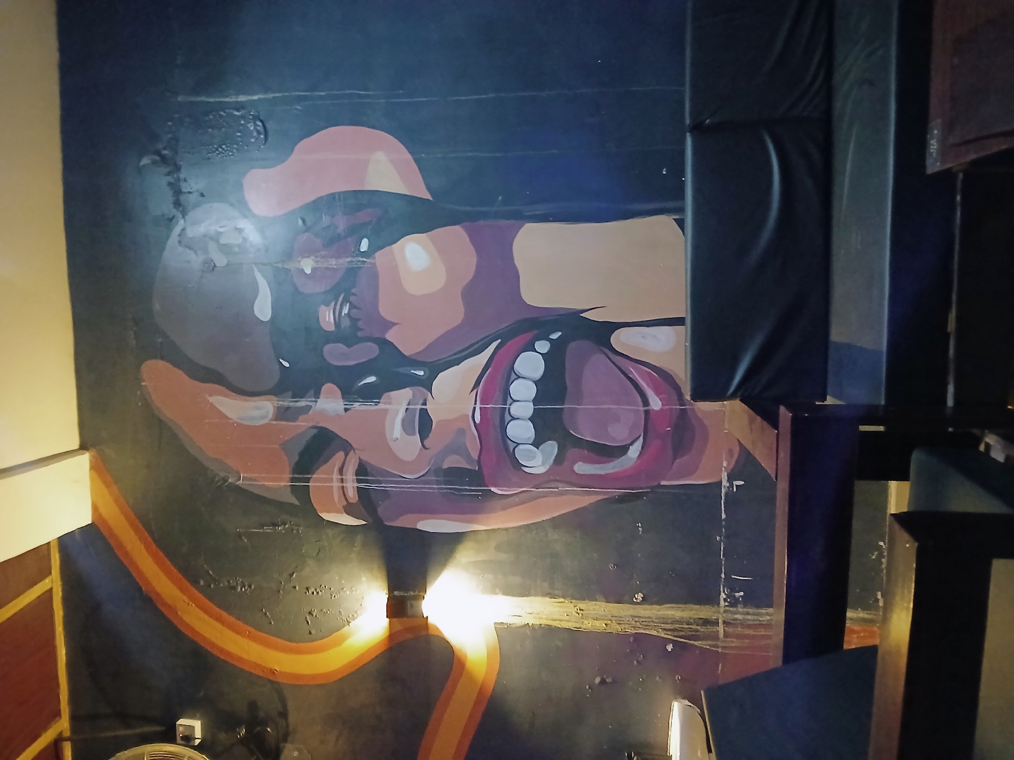 Indoor venue scenes documented in Kitwe with mural art
