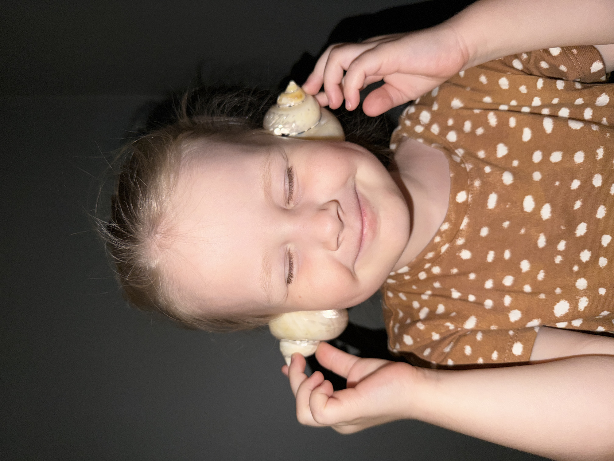 Child explores seashells in quiet moment in Khimki