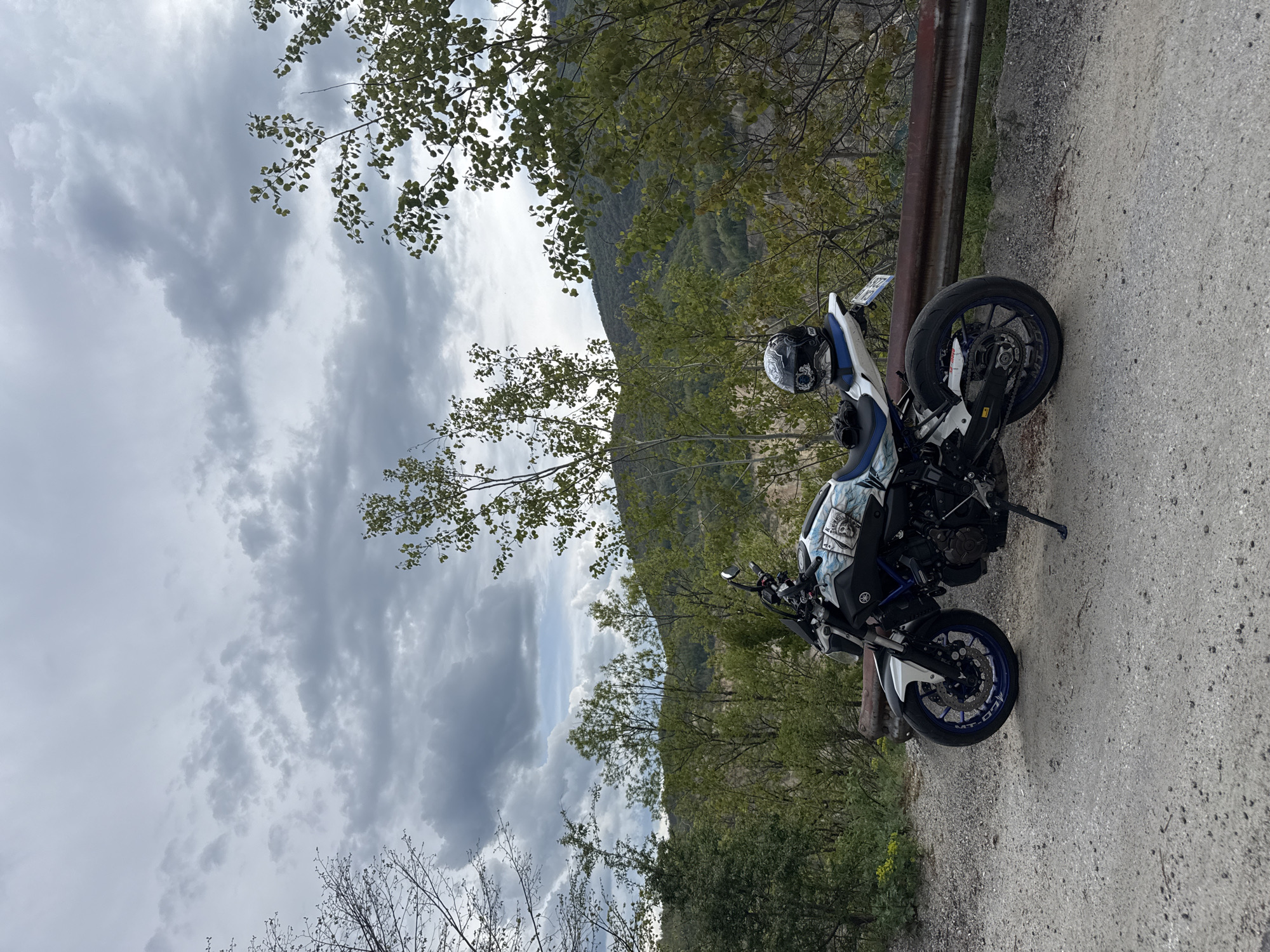 Motorcycle parked on gravel road in Bulgarian village