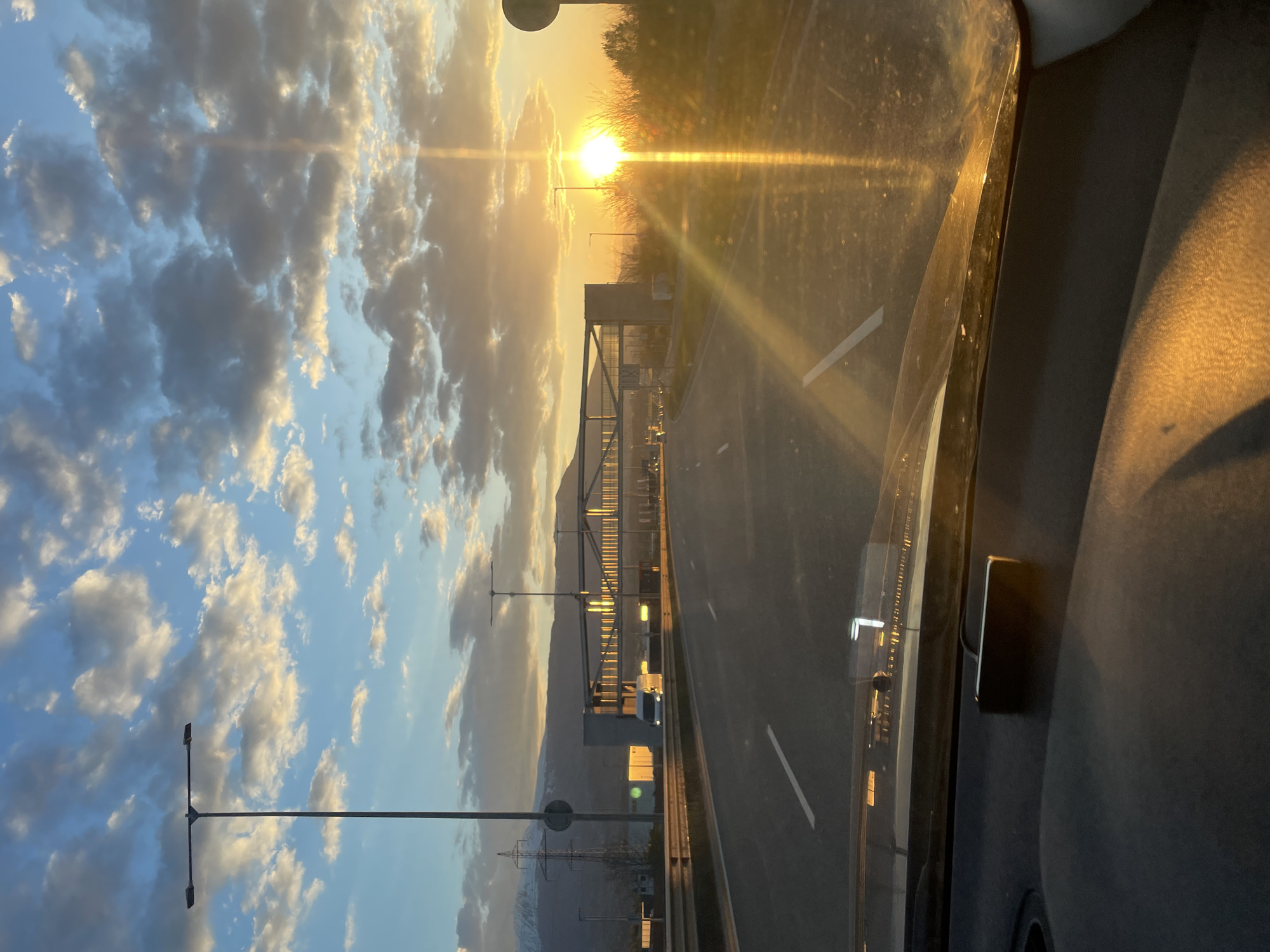 Highway journey through mountains captured in dramatic lighting