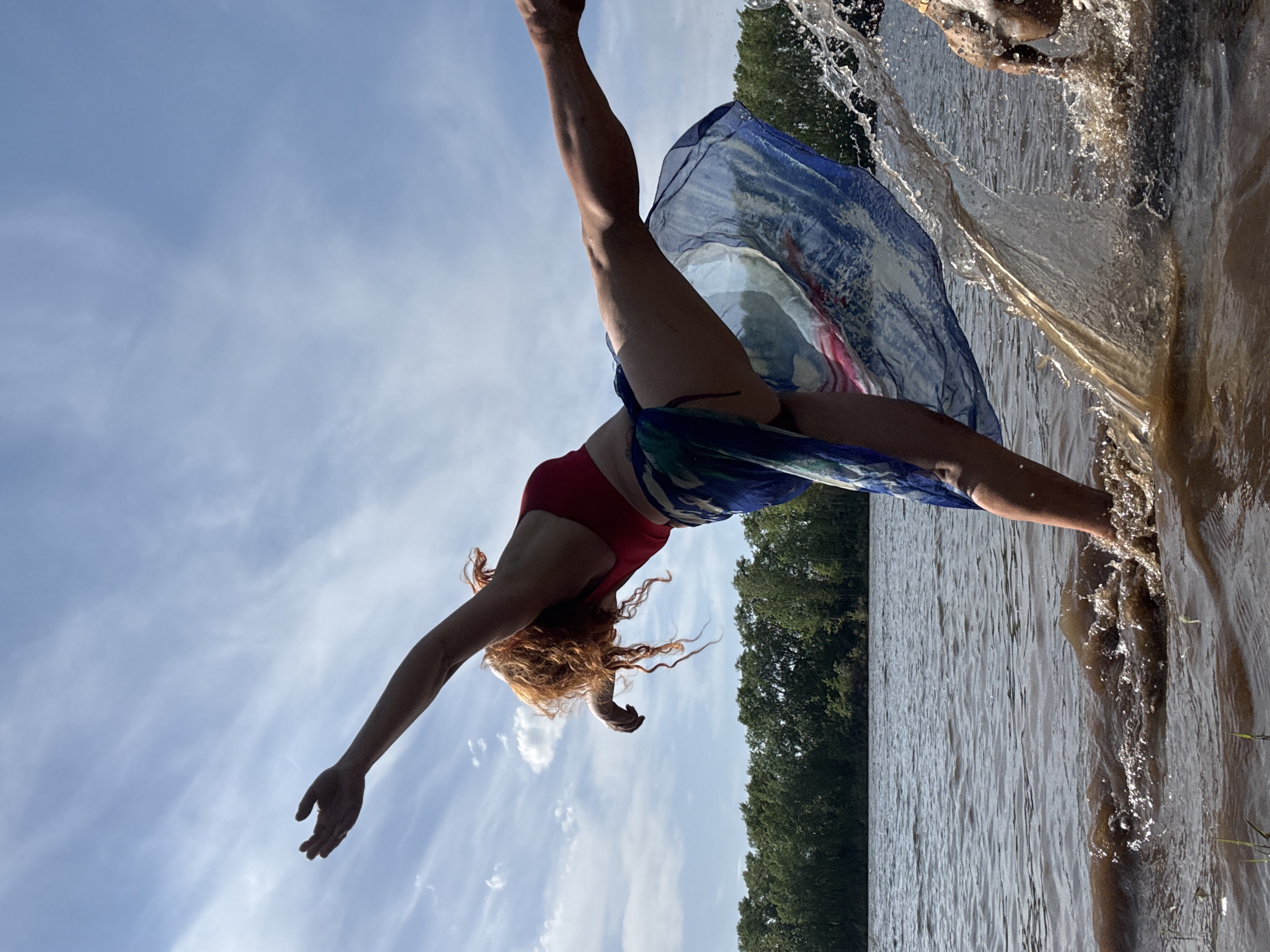 Woman dives into water wearing scarf in Chaikovsky