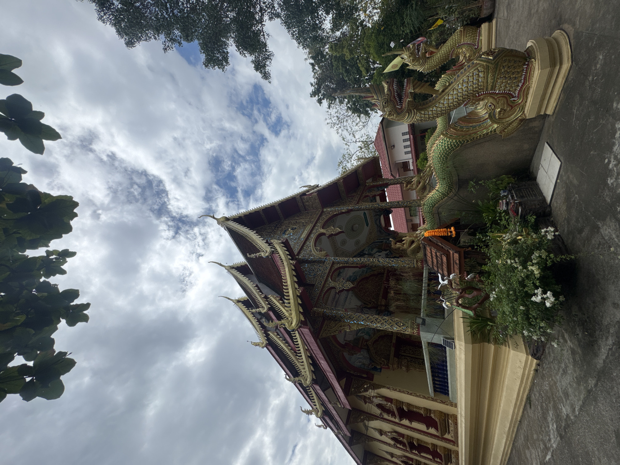 Visitor documents Buddhist temple complex in Ban Sai Kham, Thailand