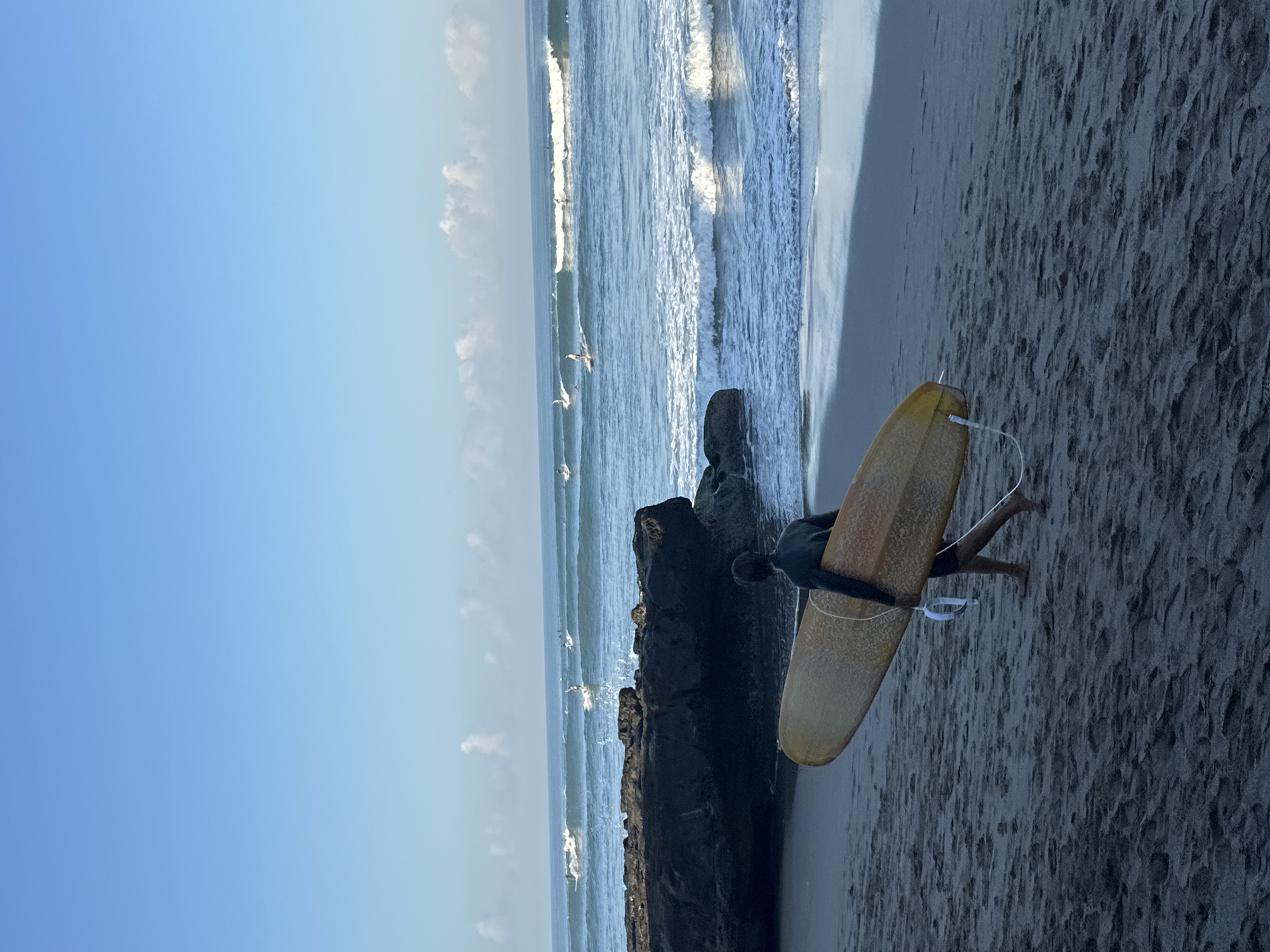 Surfers, shops, and beach life along North Kuta's shoreline