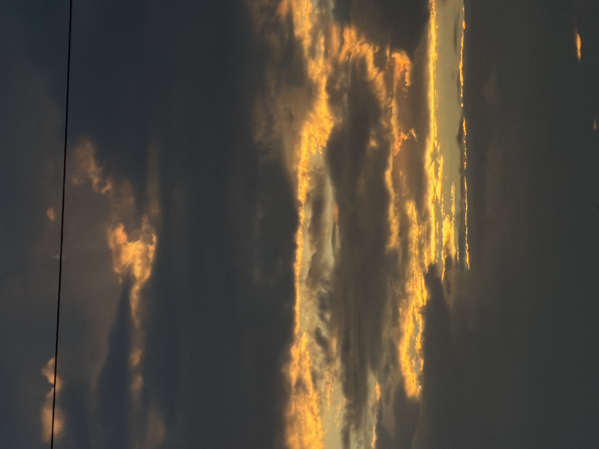 Dramatic sunset clouds over Gorzów, with a cold drink inside