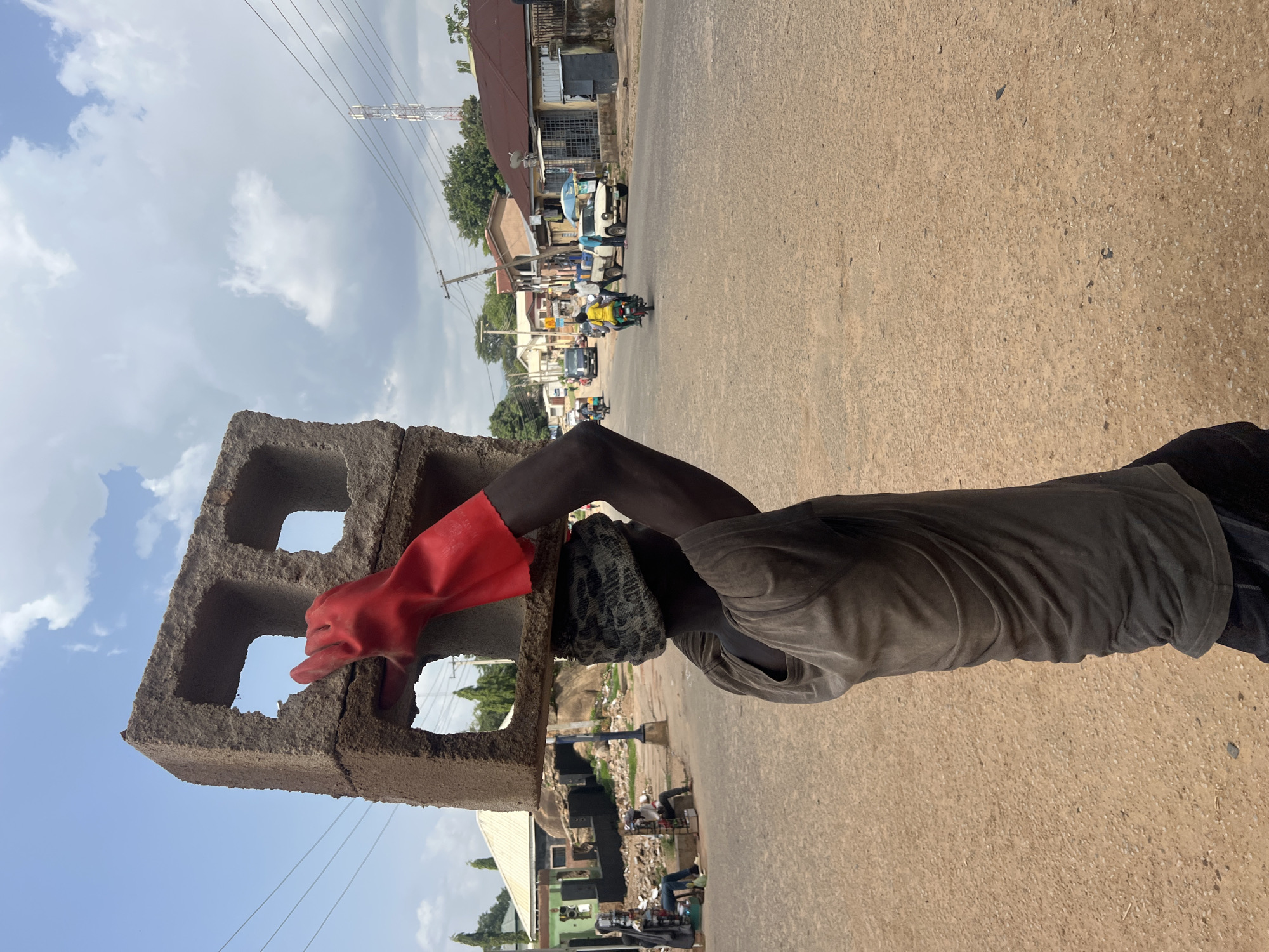 Street market activity in Jos under a cloudy sky