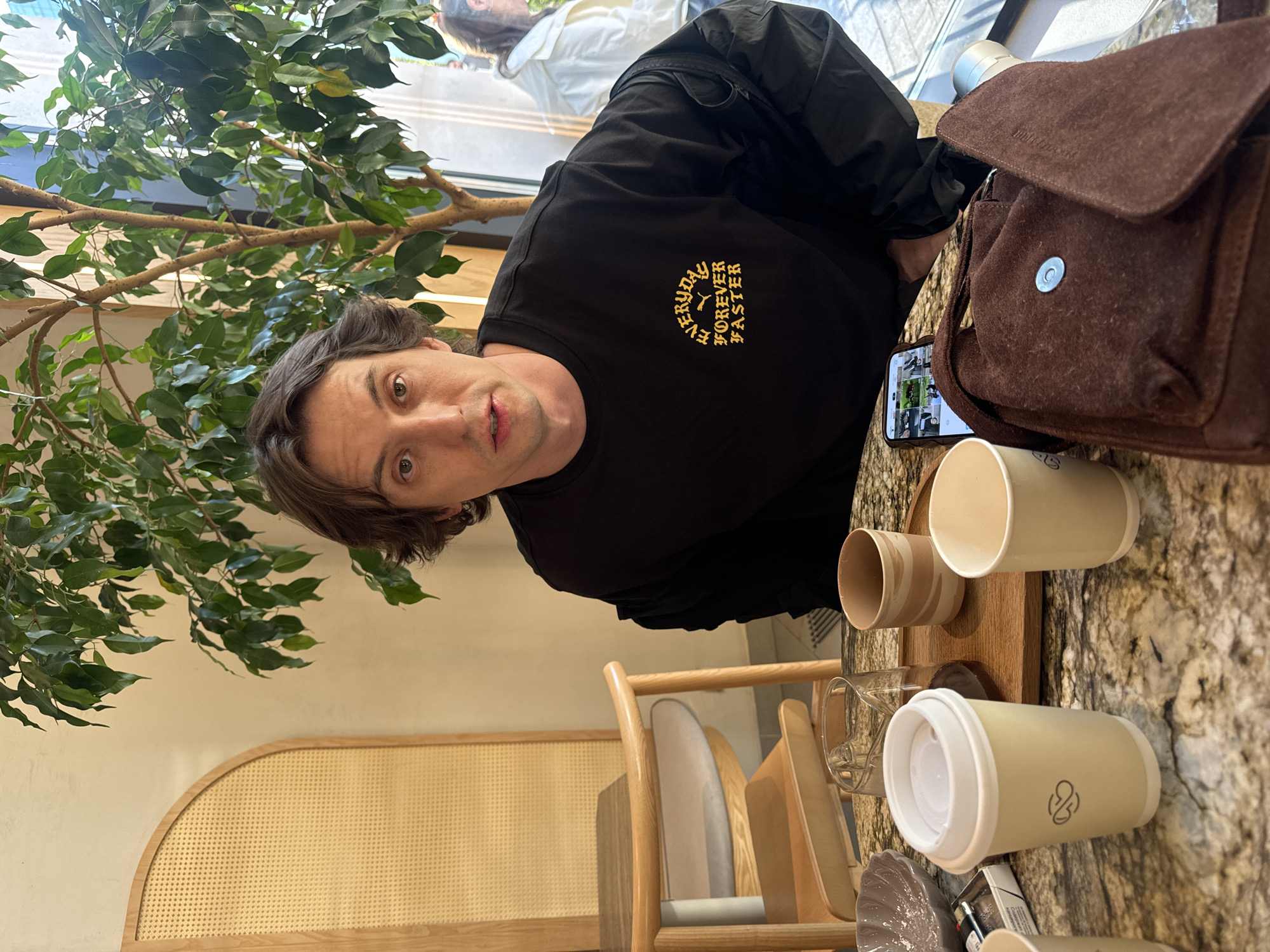 Moscow cafe patron enjoys matcha cake at marble table