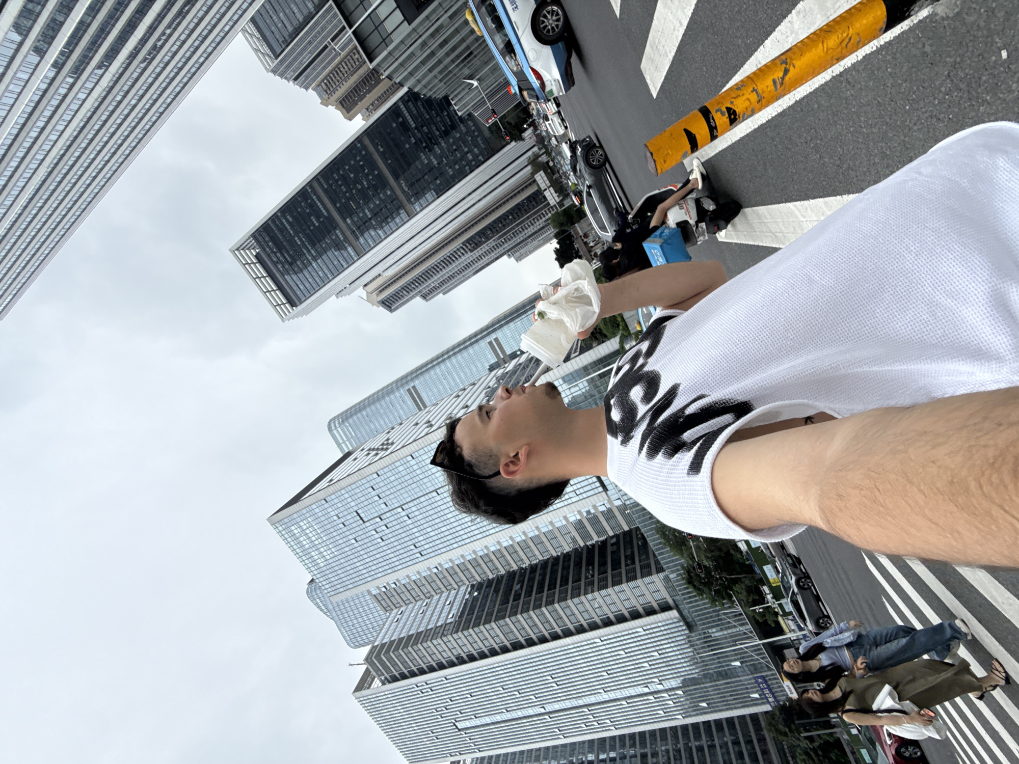 Man takes selfie with food container on Nanshan street