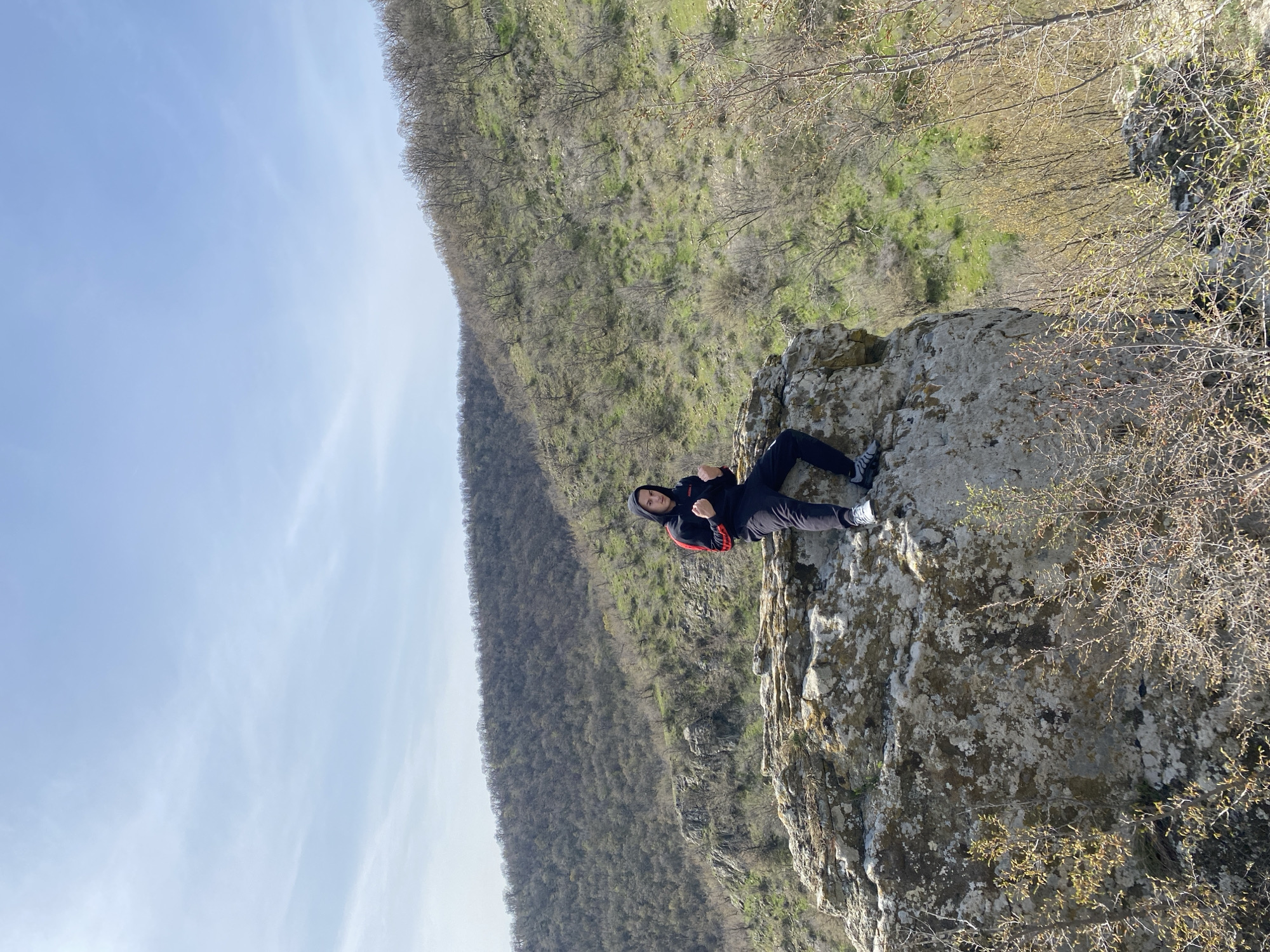 Person rests on rocky outcrop in Goritsa, Bulgaria