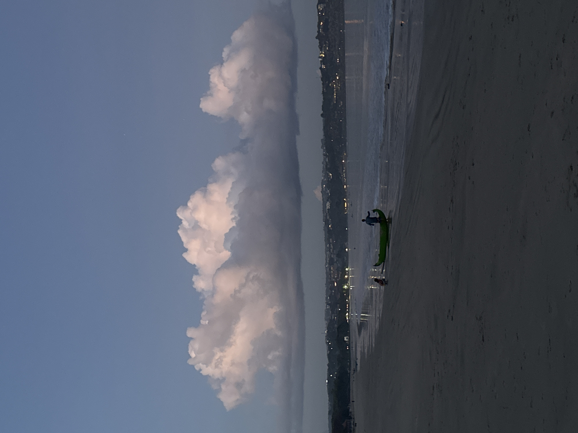 Evening beach scene documented at Kuta with boats, clouds