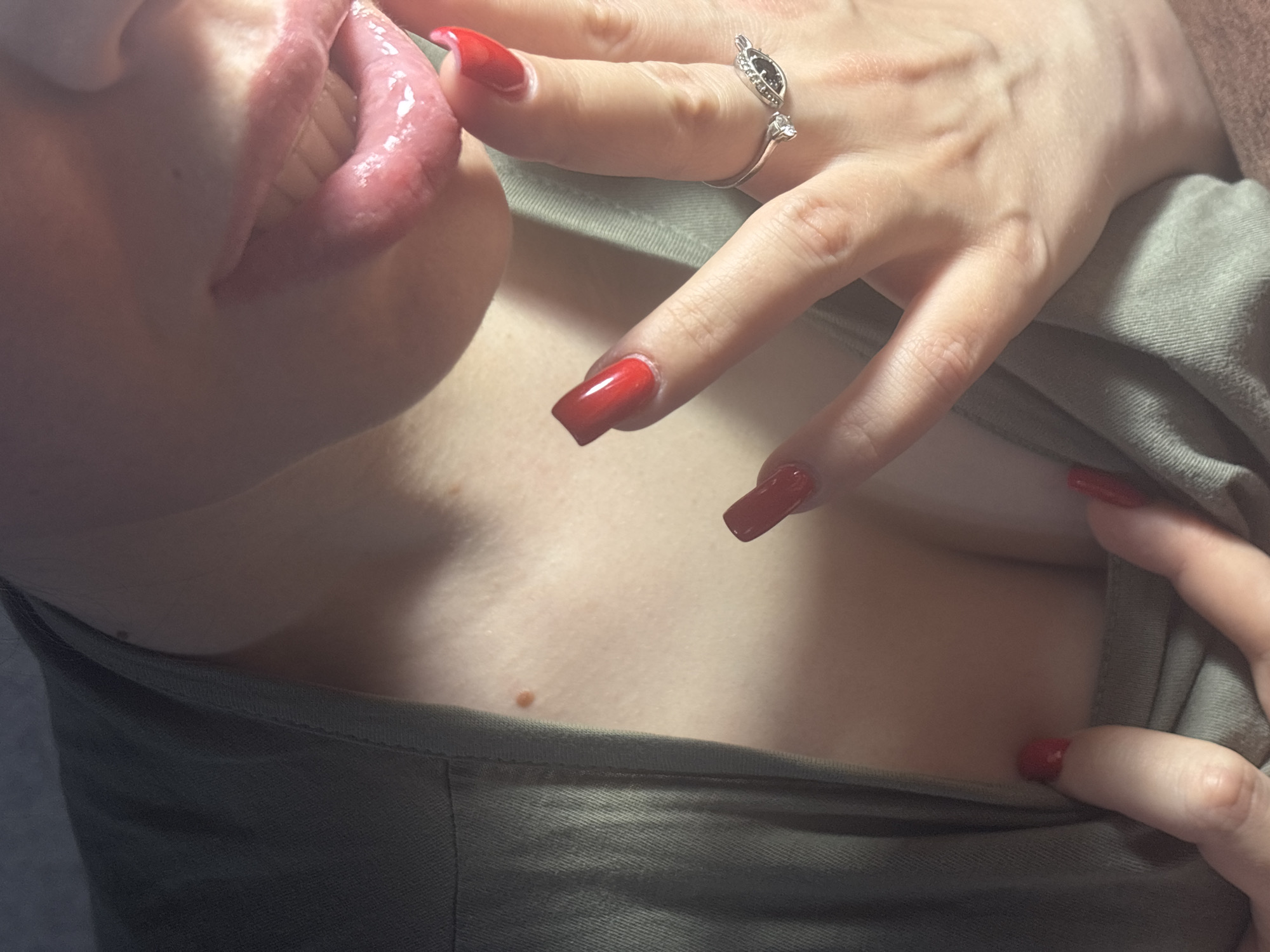 Close-up series: red nails, green top, pink drink
