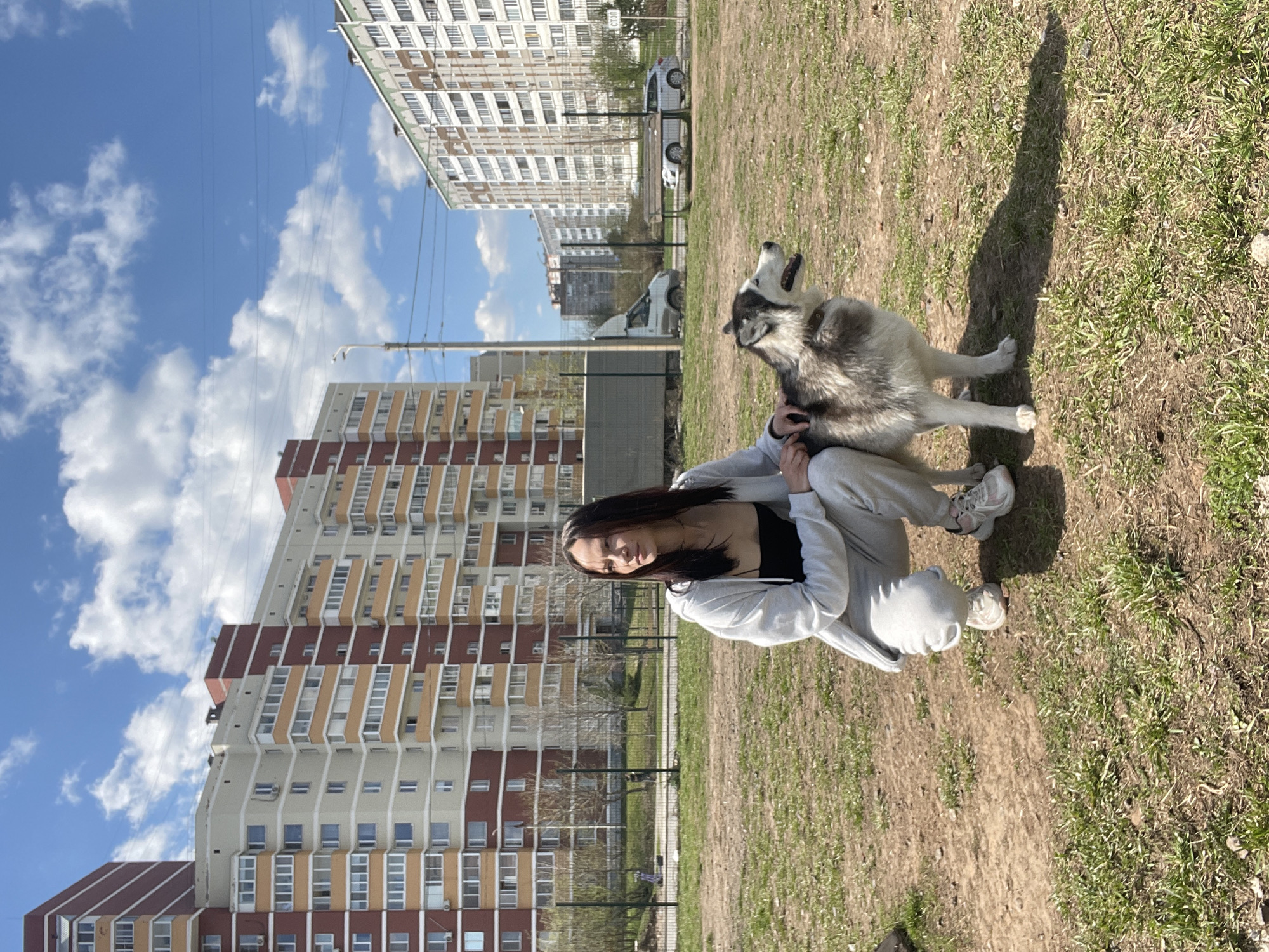 Woman with husky dog enjoys sunny morning in Izhevsk park