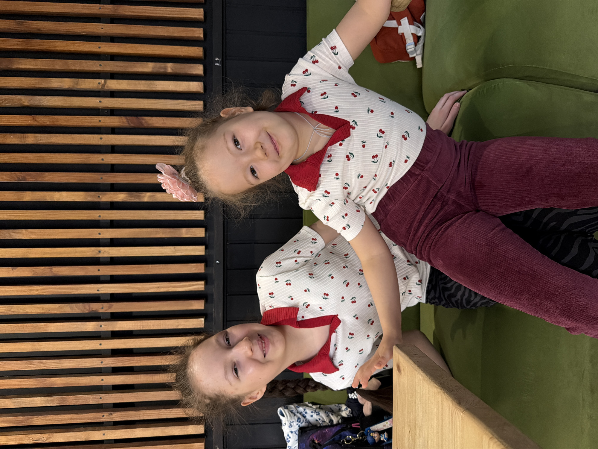 Two girls pose in matching cherry-print shirts in Izhevsk