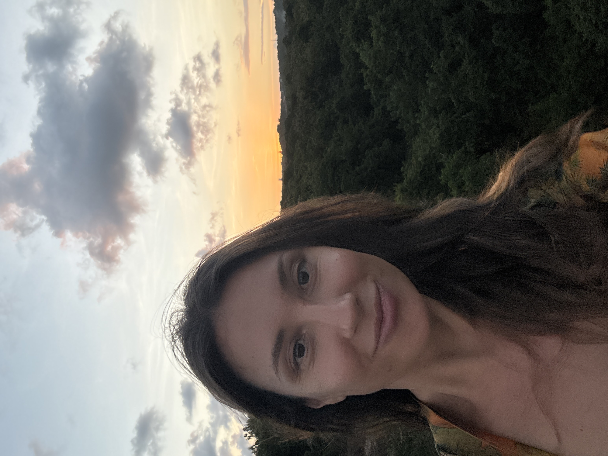Woman captures sunset moments near Kuta Selatan airport signs