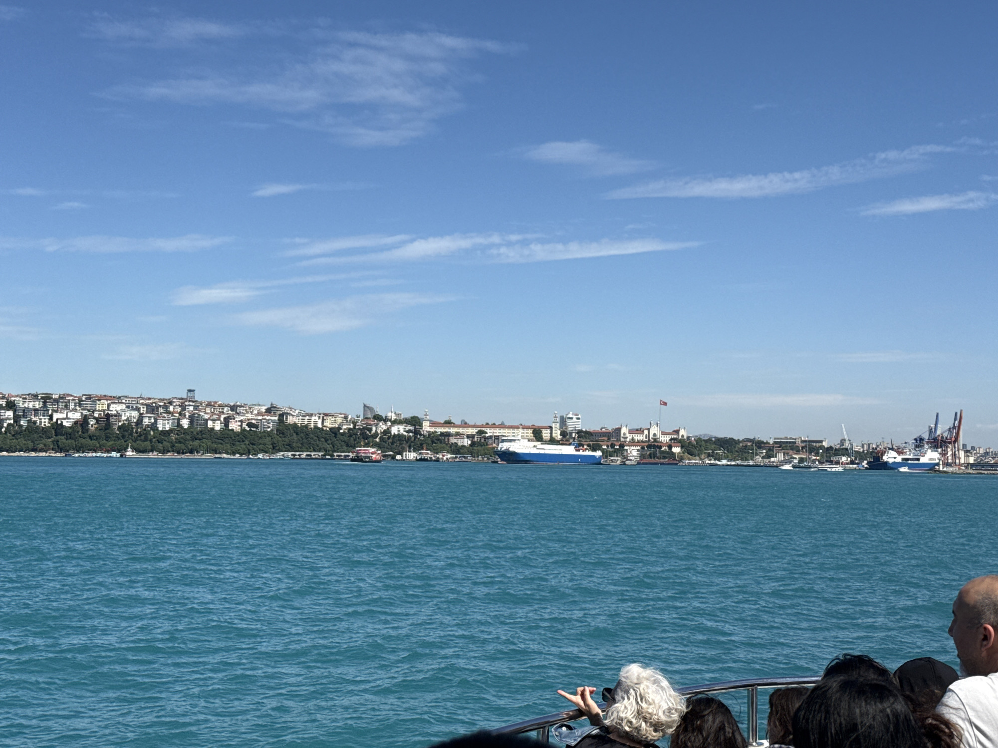 Ferry carries passengers across Bosphorus with Istanbul skyline backdrop