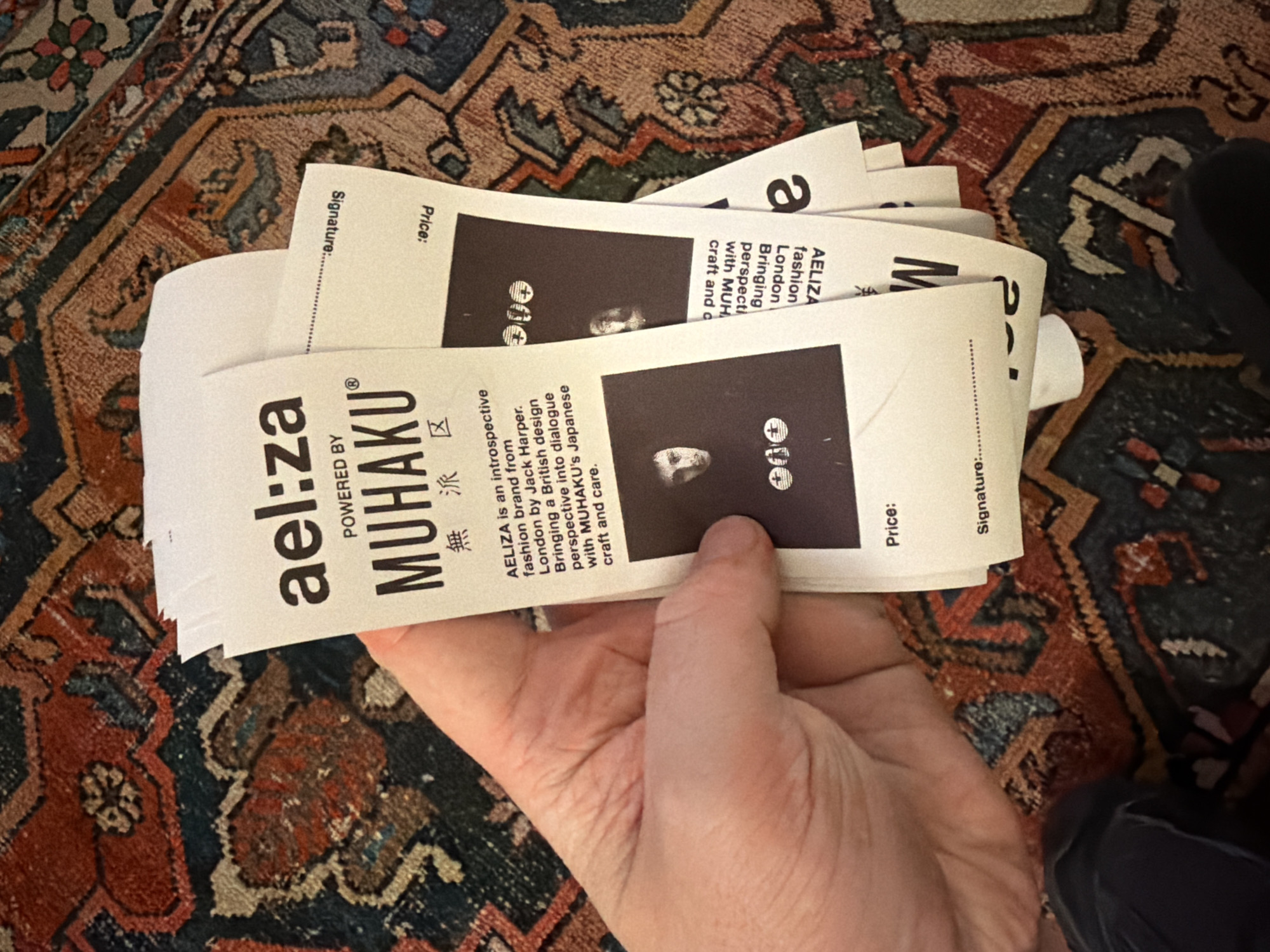 Person holds mysterious white tags with face symbols in NYC