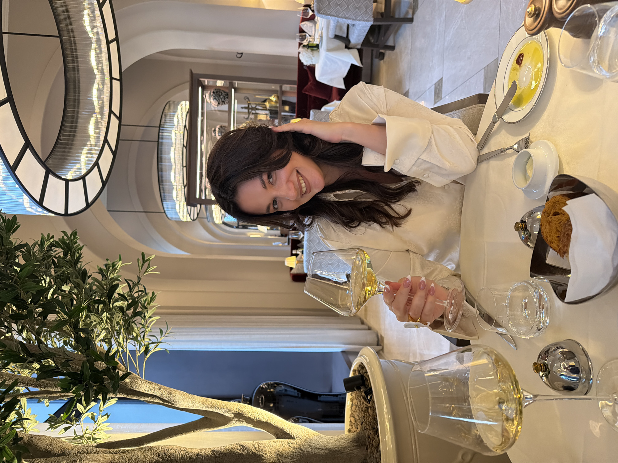 Woman dines at Belgrade restaurant with wine and food