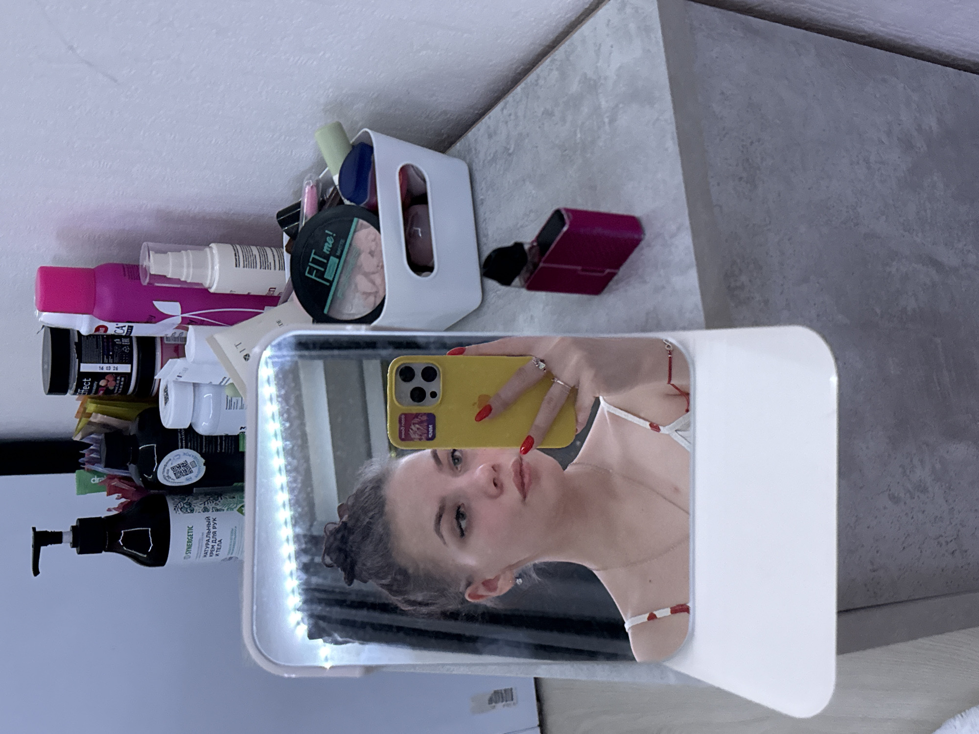 Mirror selfie captured with yellow phone in Yekaterinburg