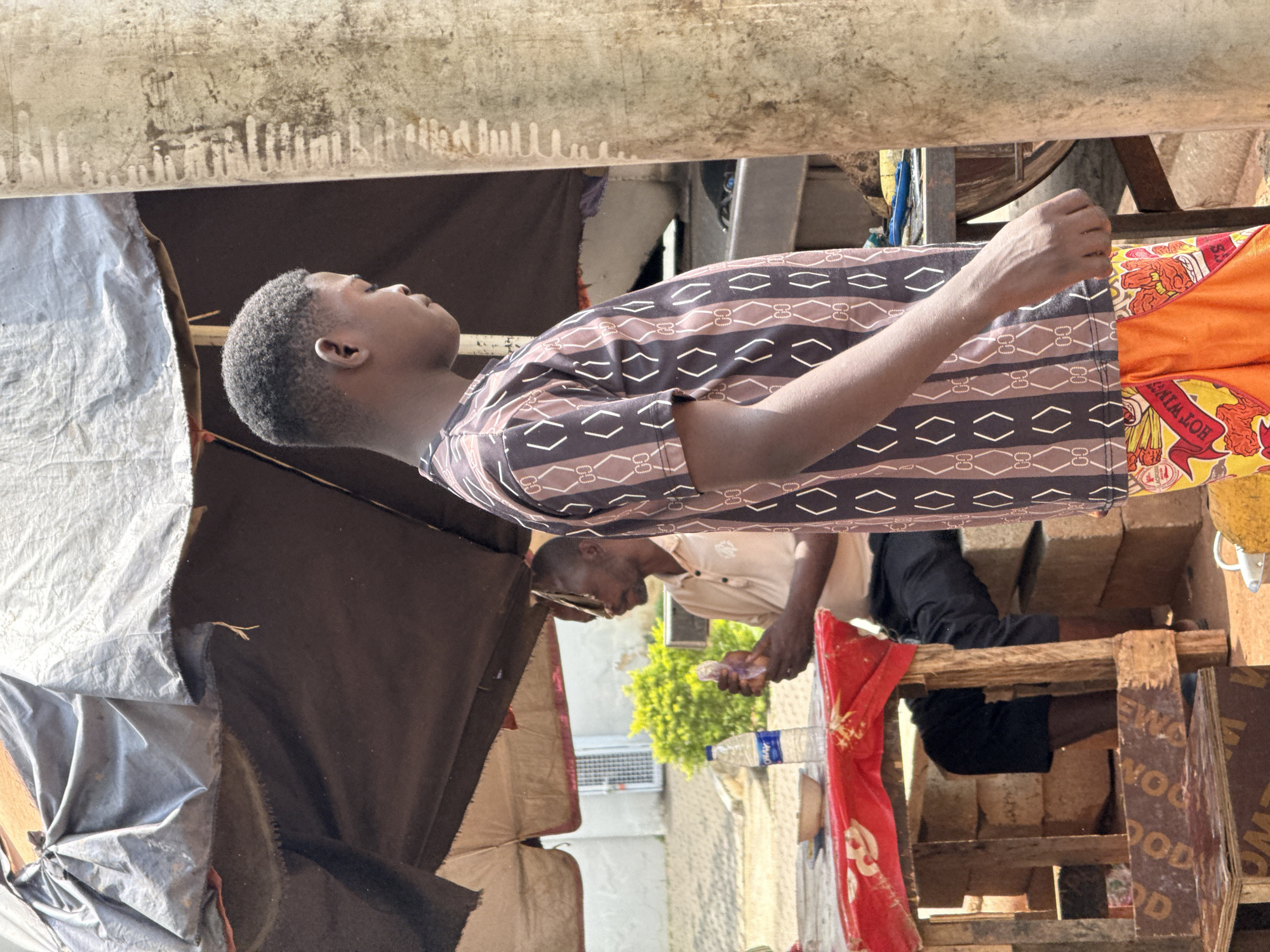 Street market activity at a busy Abuja roadside stall