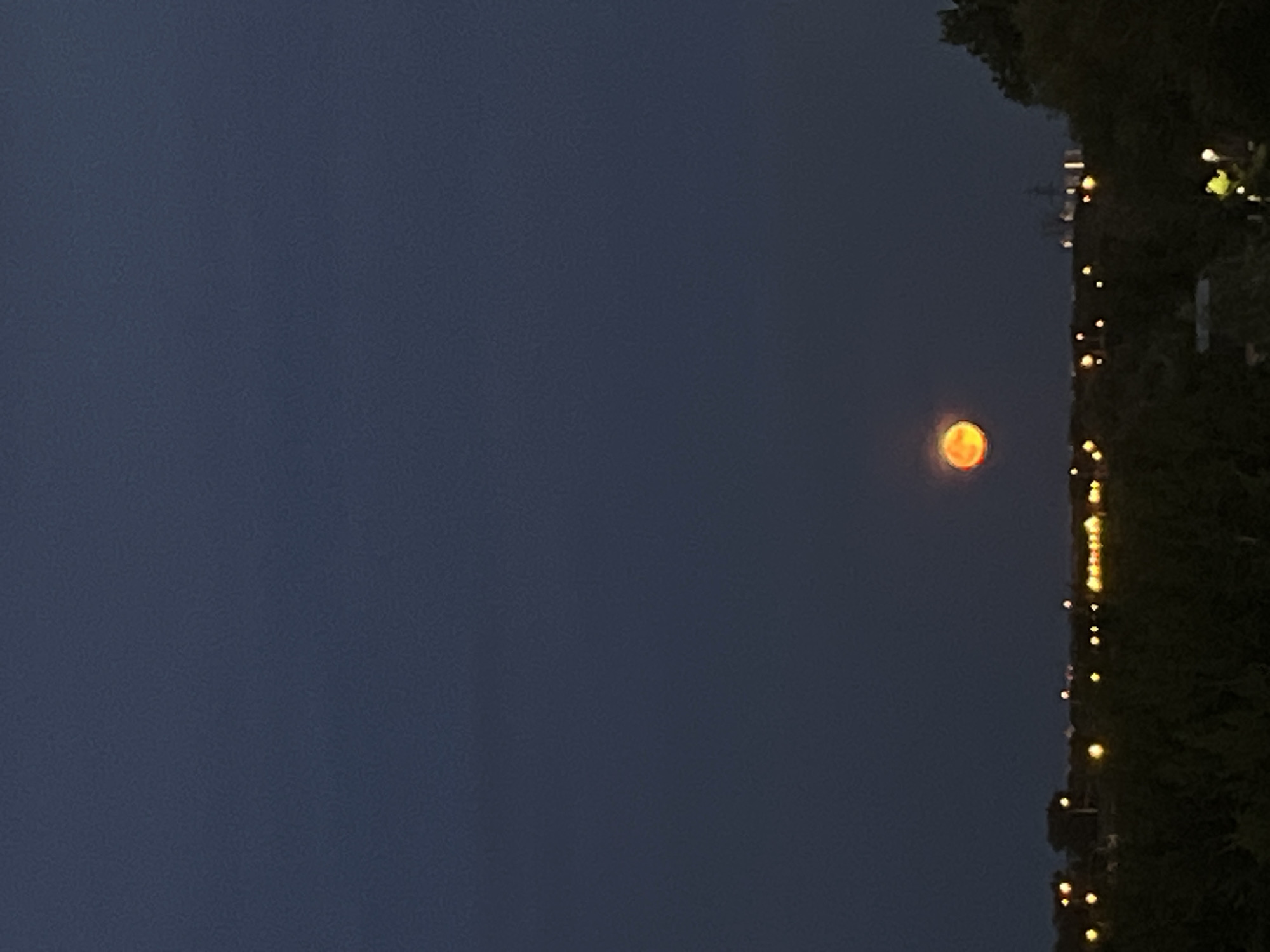 Orange moon rises over Samara at dusk