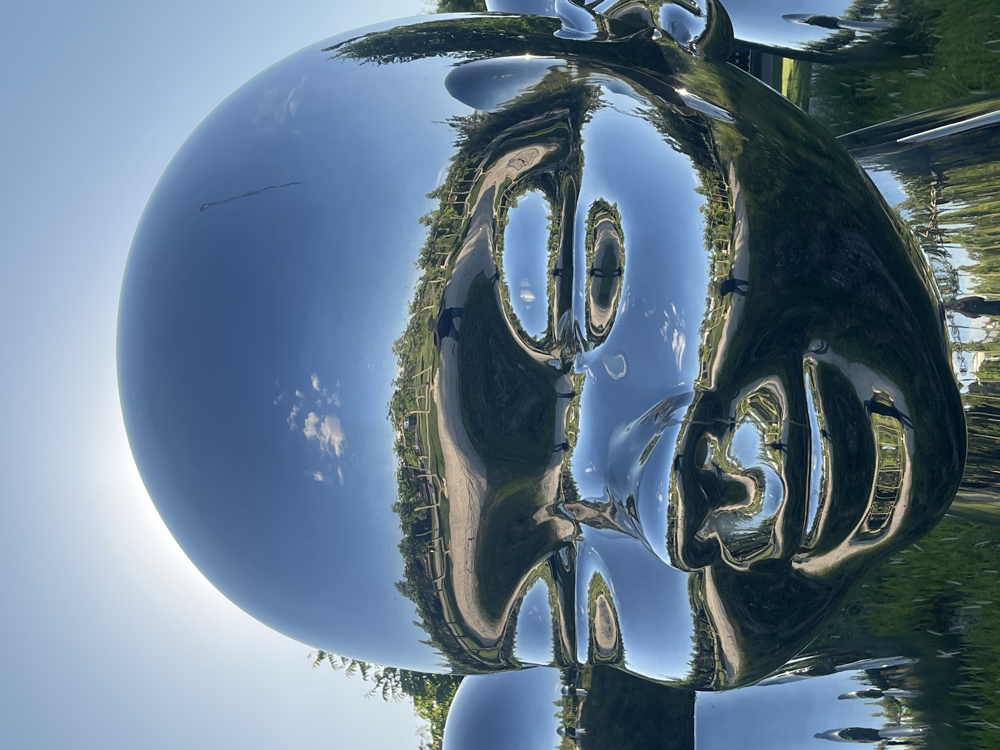 Visitors explore chrome sculpture park in sunny Krasnodar afternoon