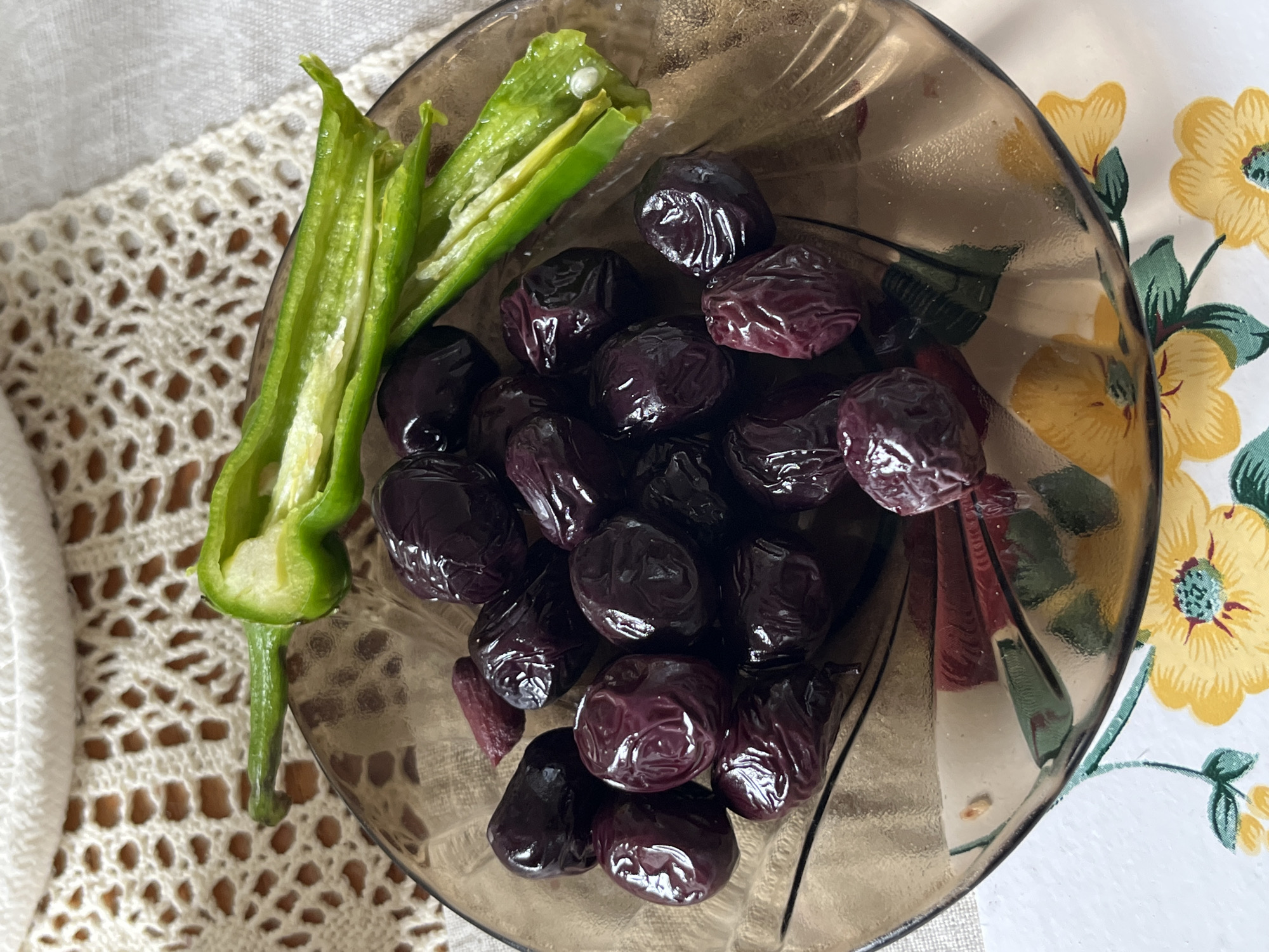 Fresh vegetables and olives arranged across multiple surfaces