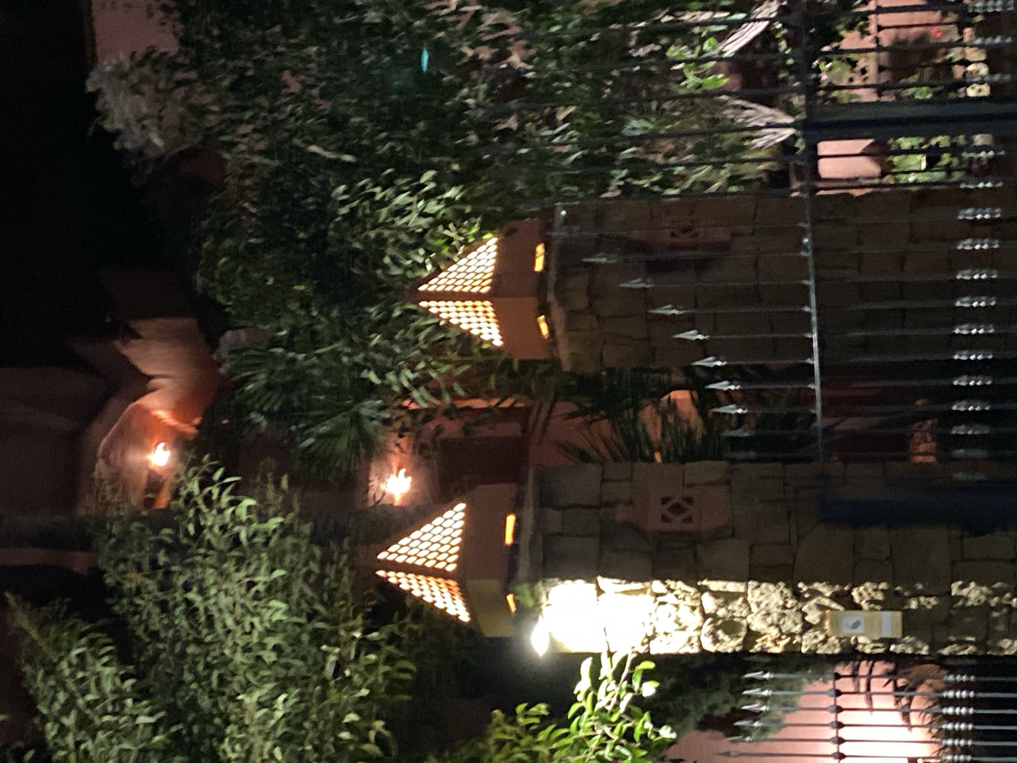 Evening around Estepona's lit gardens, pools, and fountains