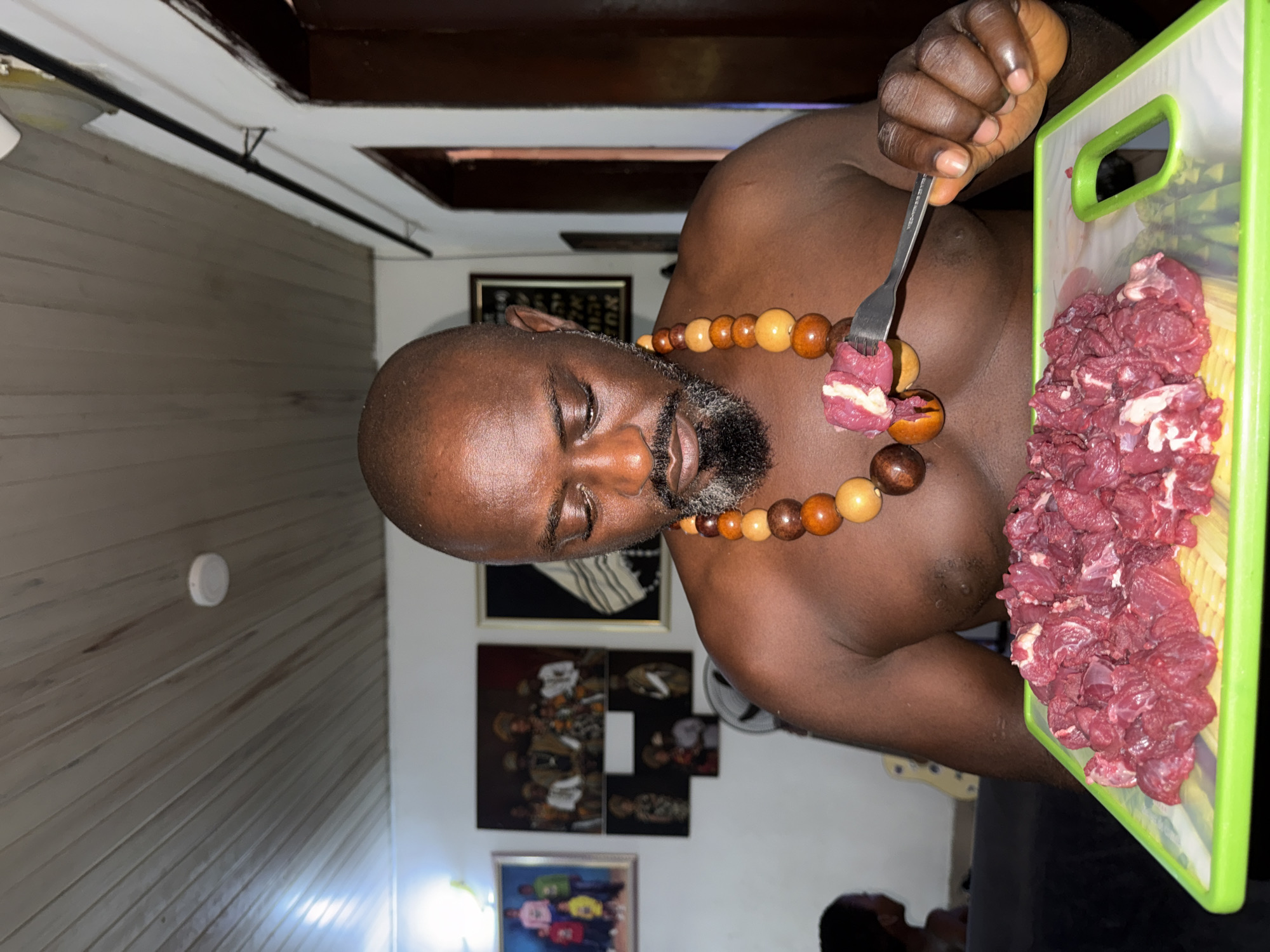 Man with wooden necklace photographed in Ado, Nigeria
