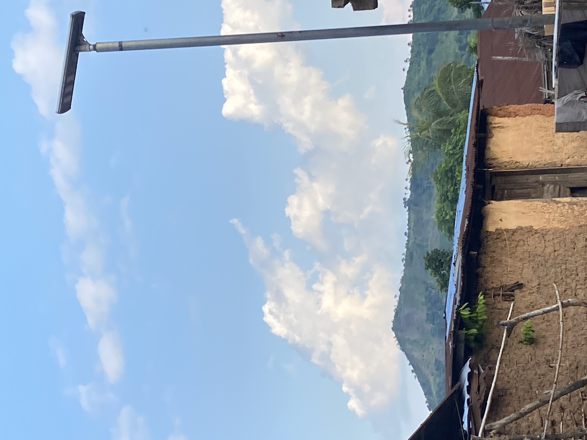 Rural Igbara: mud-brick homes and hills in late afternoon light