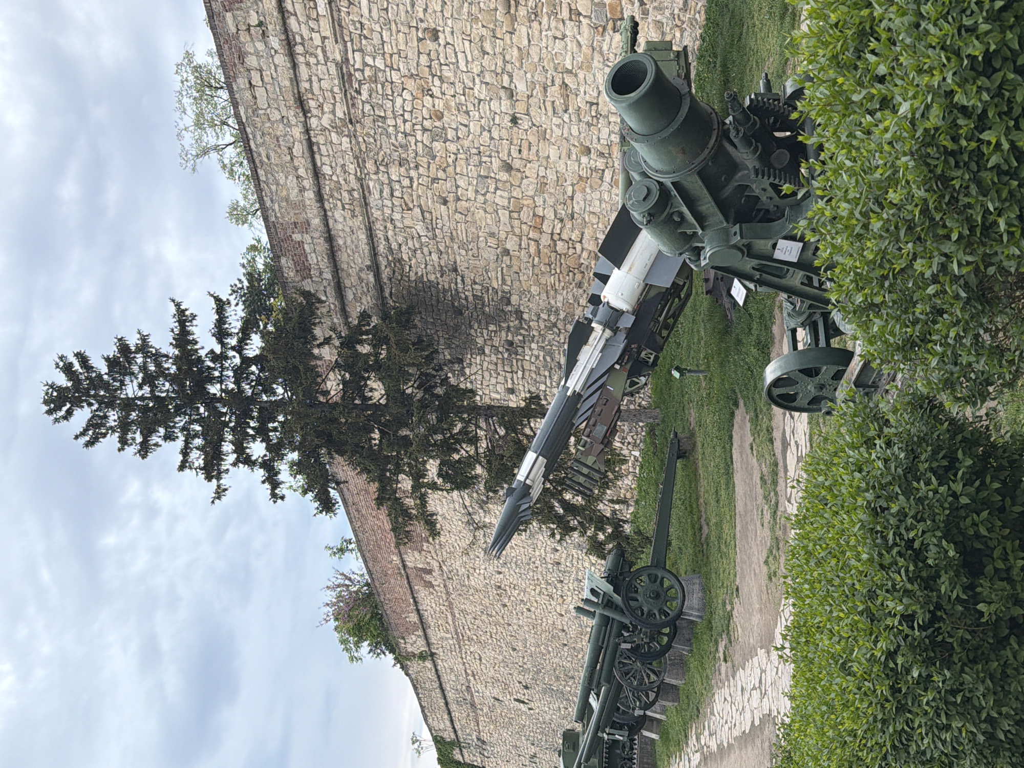 Tourist visits Belgrade Fortress military museum on overcast afternoon