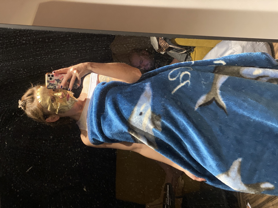 Person takes mirror selfie wearing gold mask in Russia