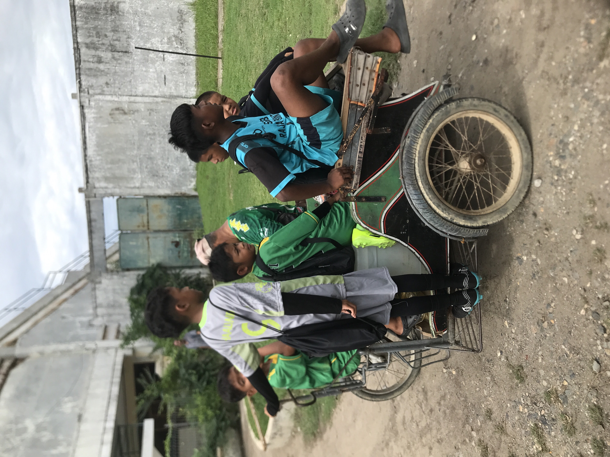 Four youths share modified bicycle with sidecar in Lhokseumawe