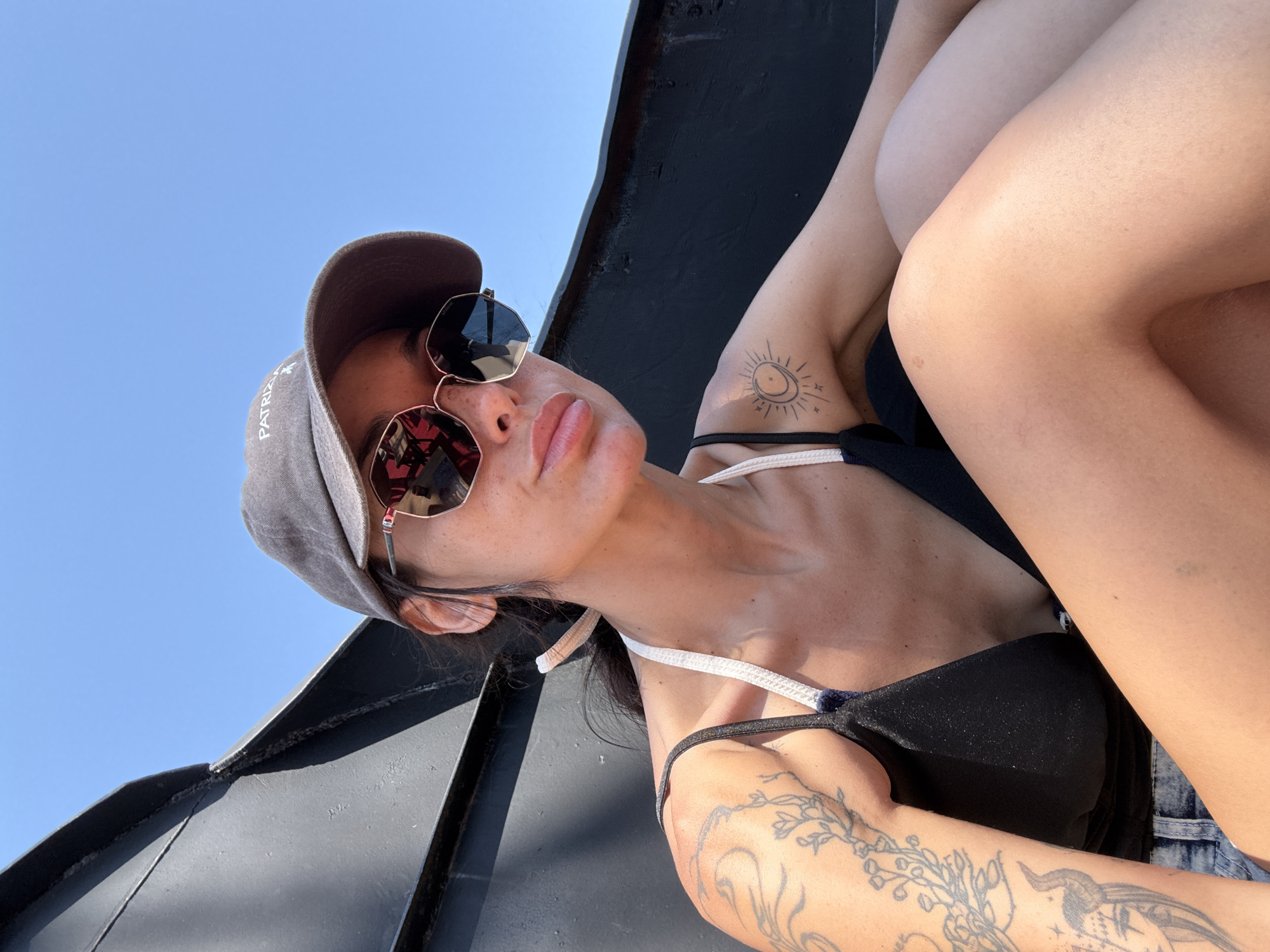 Looking up in Konyaaltı, shades and cap on