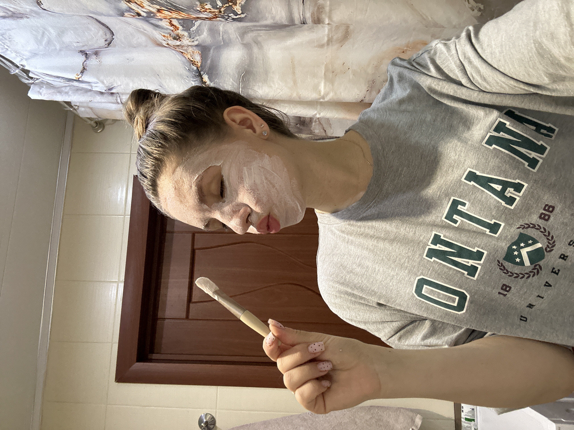 Woman documents morning skincare routine in Klin bathroom