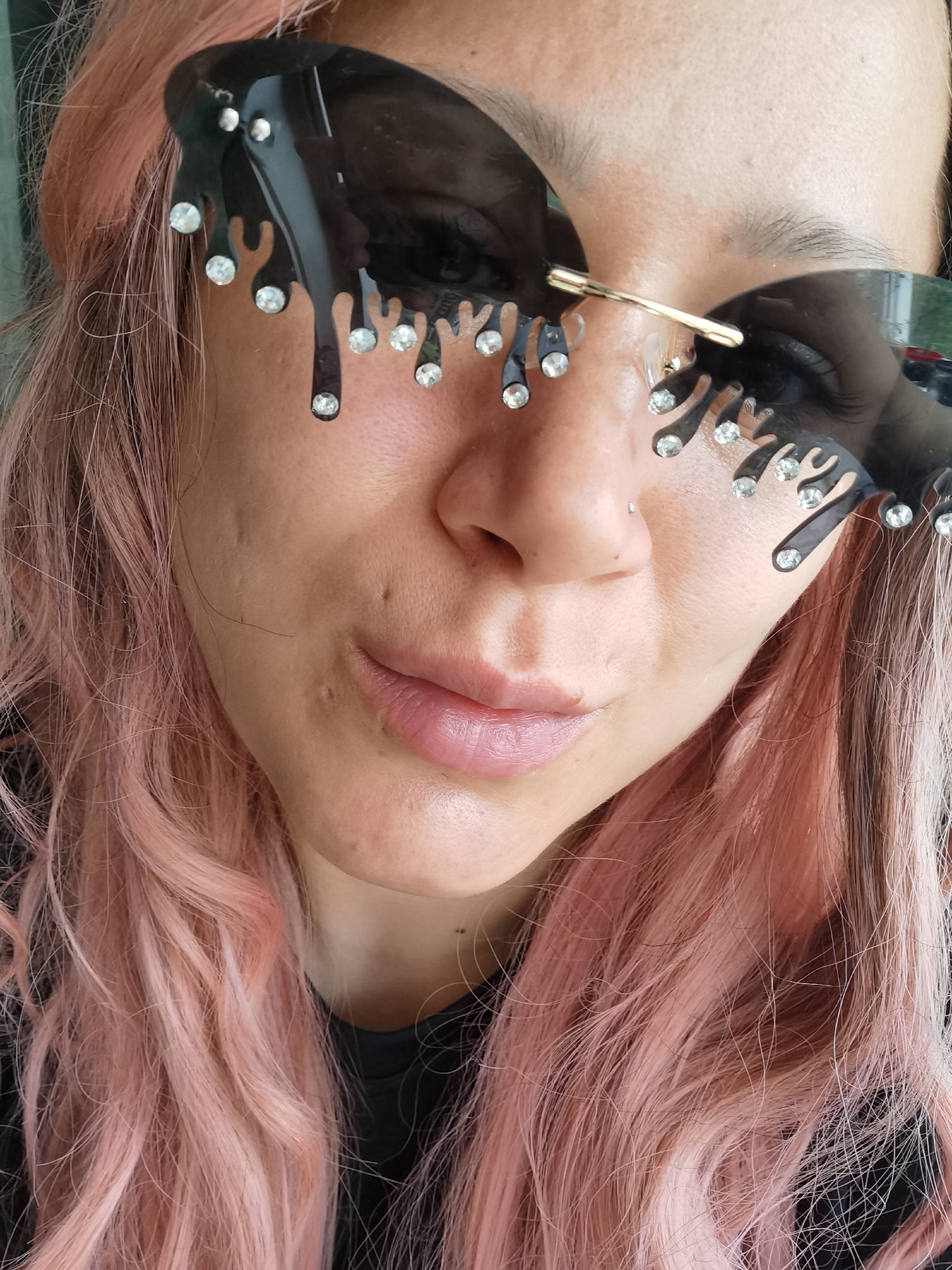 Pink-haired person photographed in decorative sunglasses in Chaikovsky