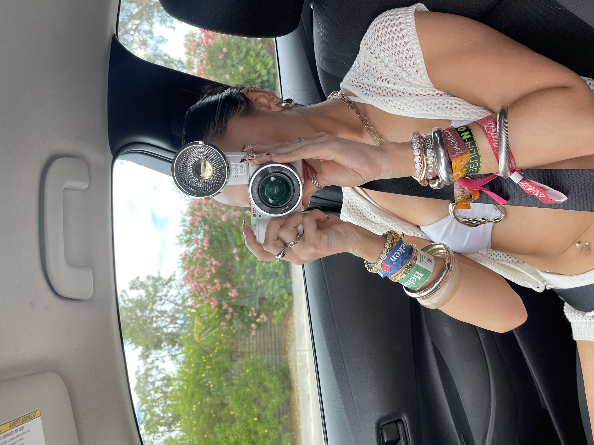 Woman photographing from passenger seat in Palm Springs vehicle