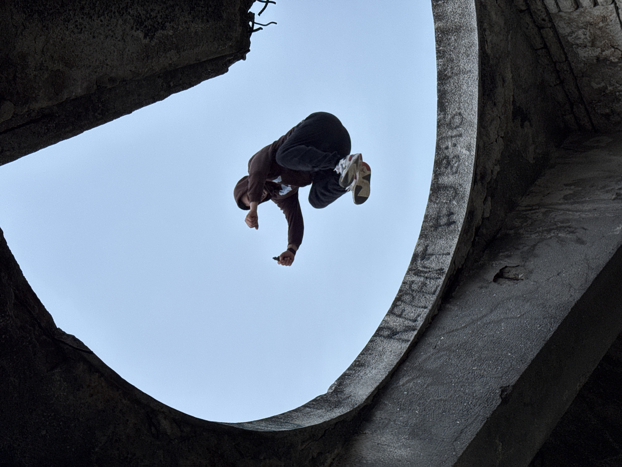 Parkour performance captured at graffitied concrete structure in Varna