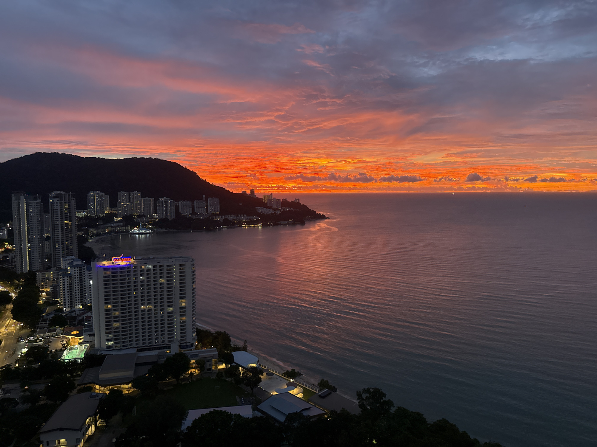 Vivid coastal sunset over George Town from above
