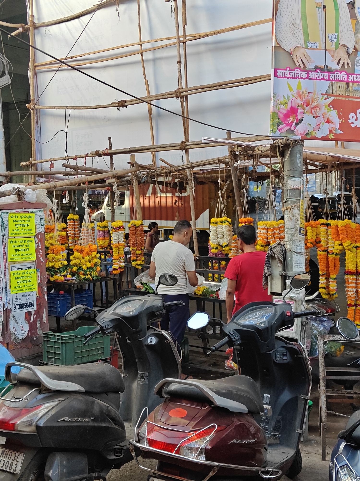 Flower vendors sell marigold garlands on Mumbai street