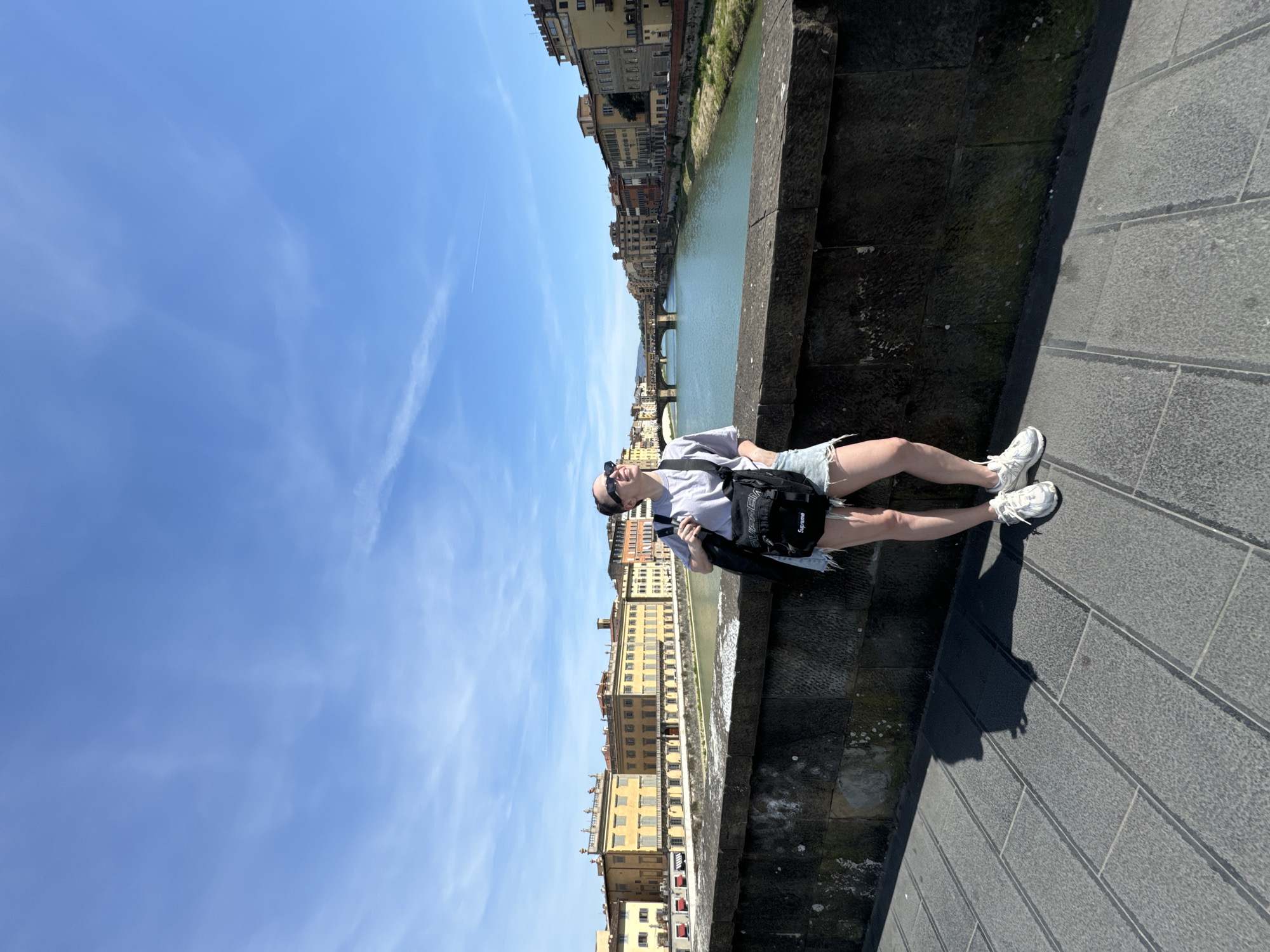 Woman observed standing on stone bridge in Florence