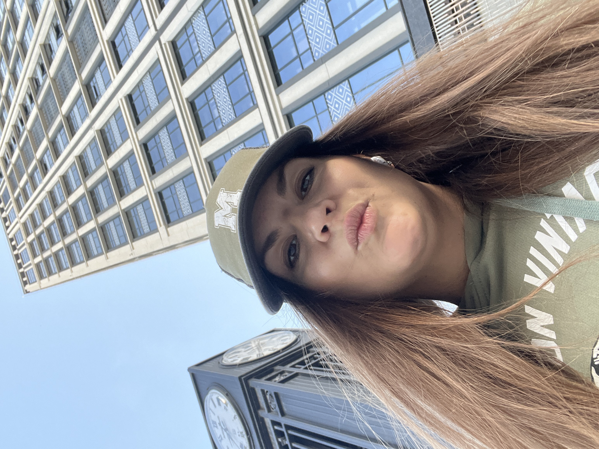 Woman takes selfie against tall building in Novosibirsk