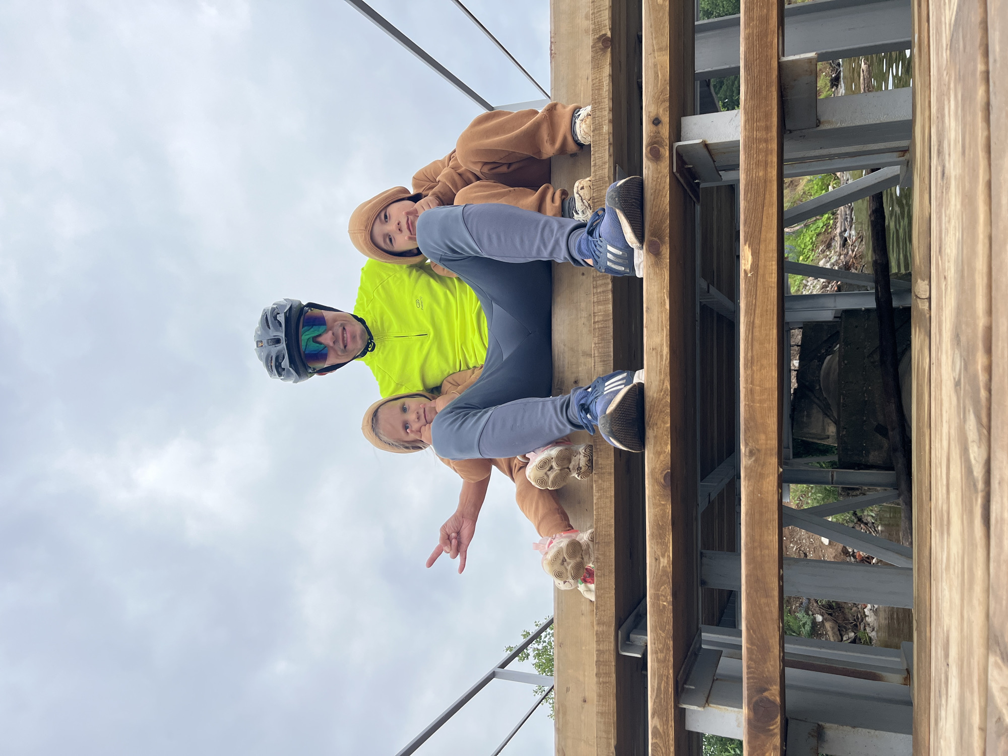 Kids, a husky, and bikes on a Chaikovsky waterfront pier