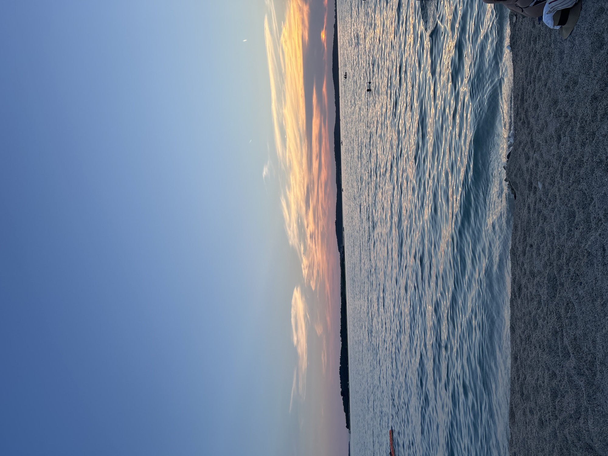 Golden hour at the beach, people winding down at dusk