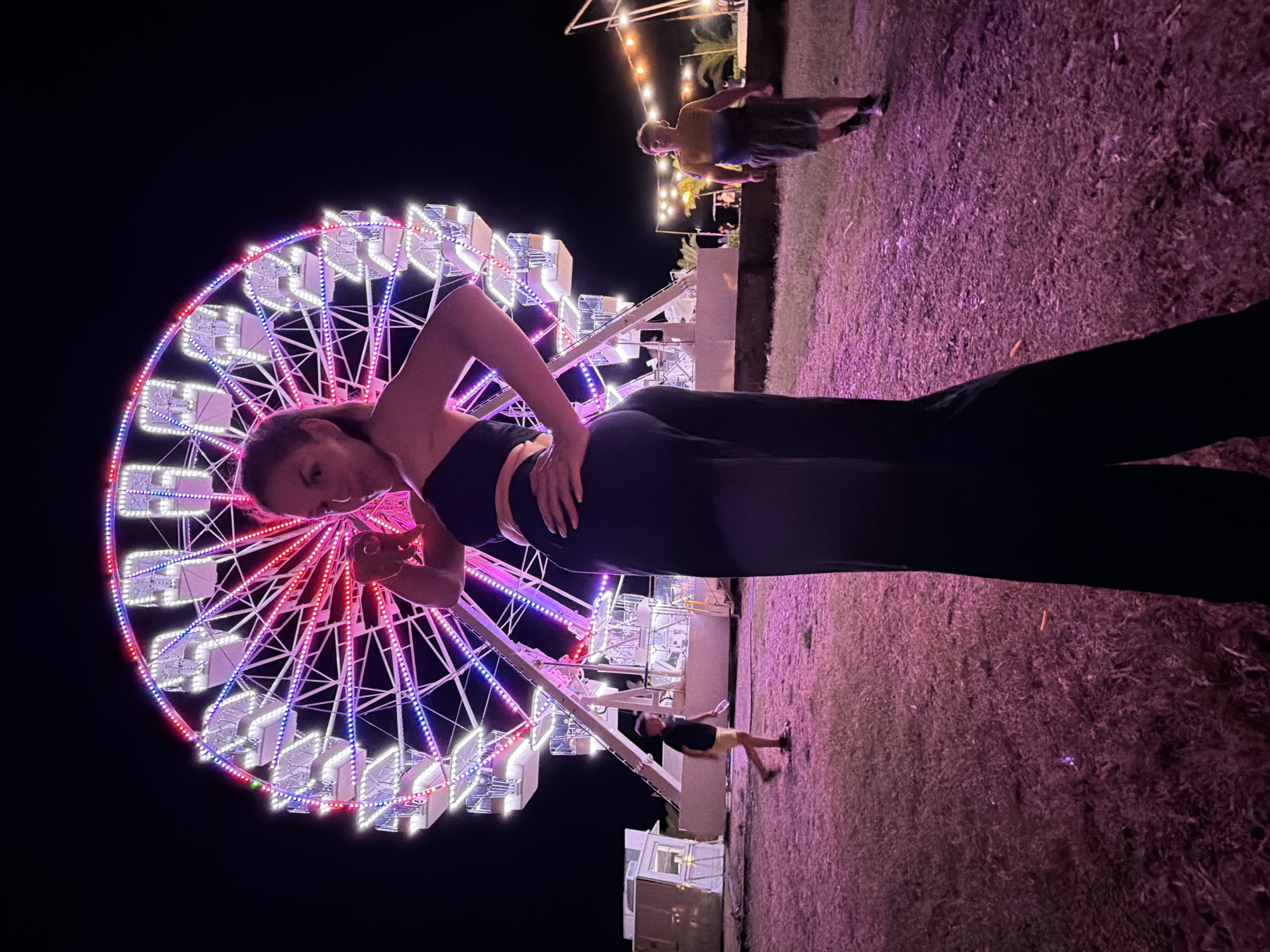 Budva fairground night: Ferris wheel draws a lively crowd