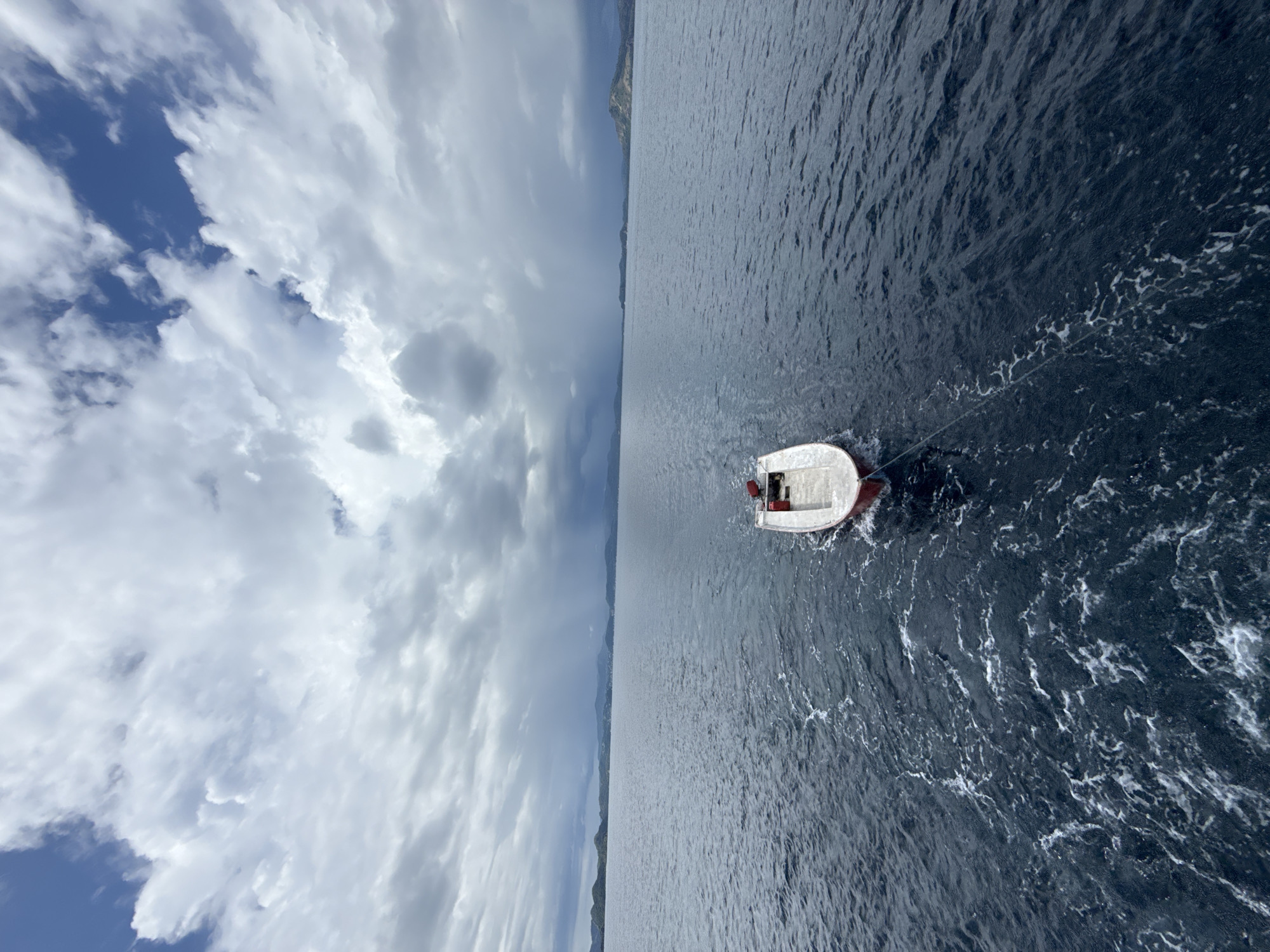Motorboat towed across choppy waters near Pasir Putih, Indonesia
