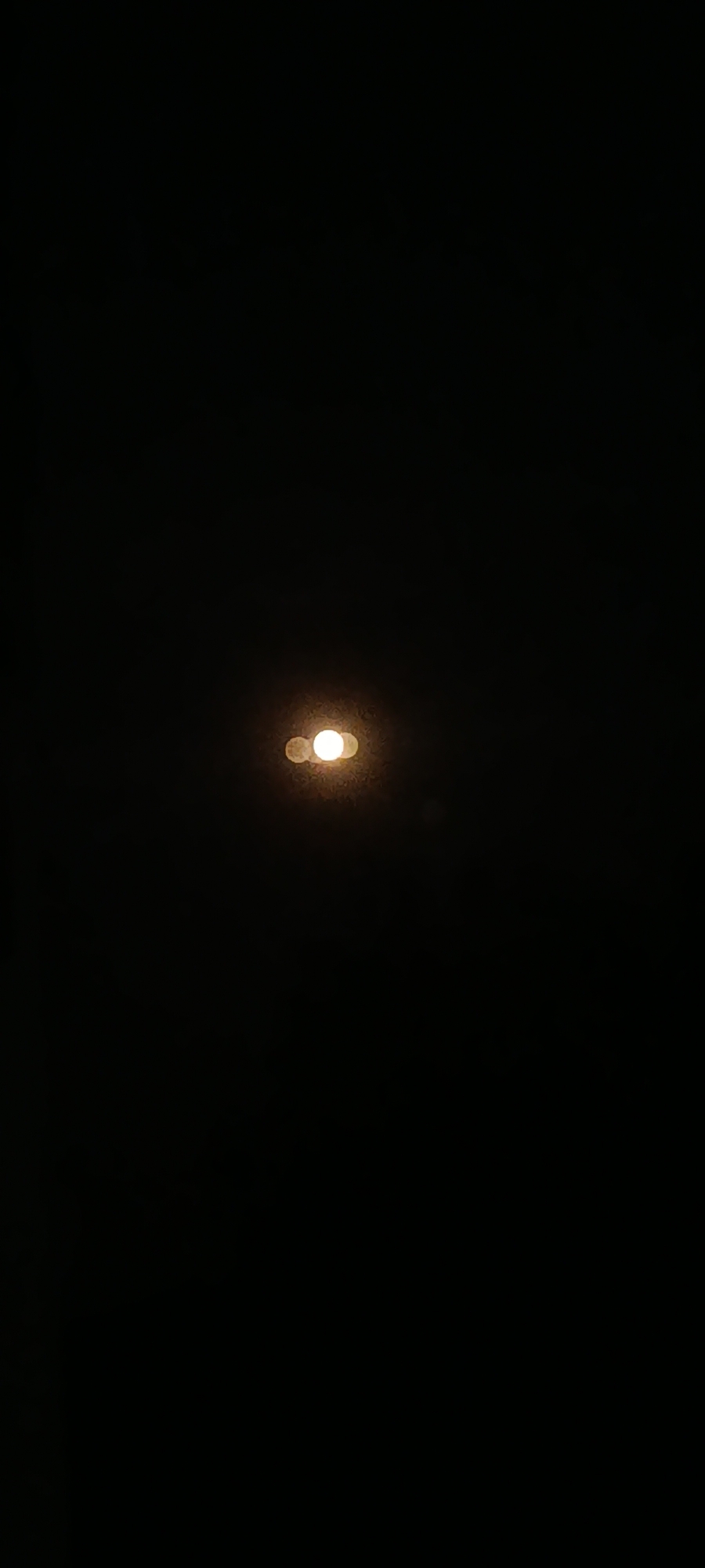 Close-up nighttime shots of street lights glowing against dark skies