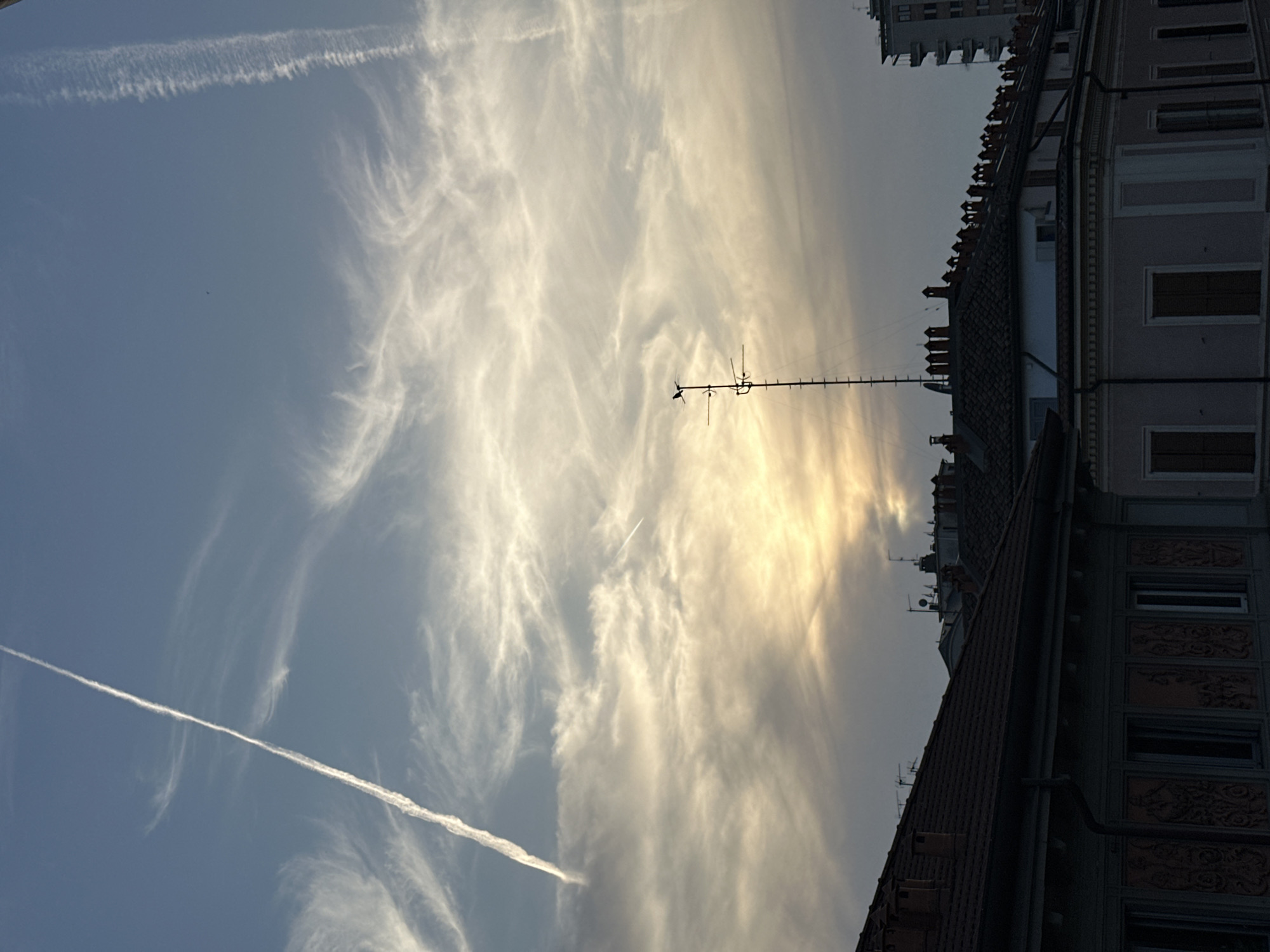 Milan skyline view captured showing red-roofed building with antenna